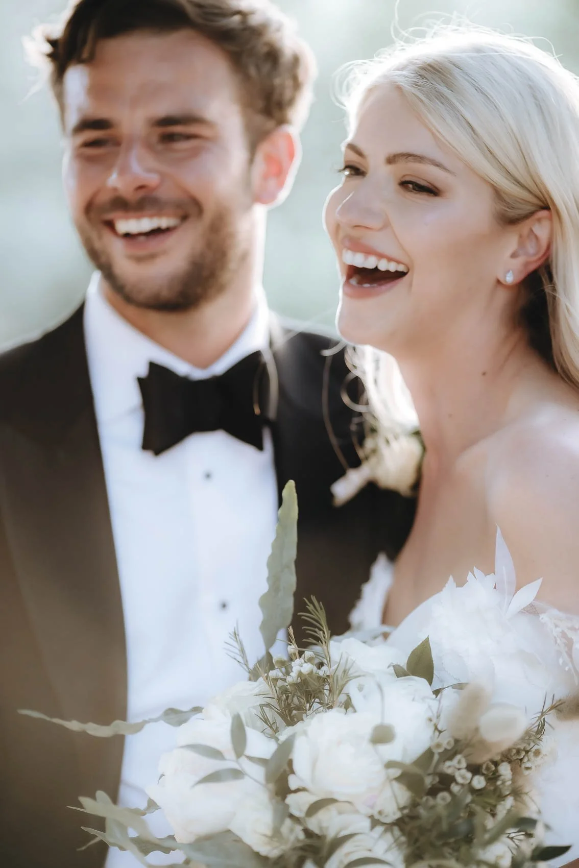 candid moment of the bride and groom laughing at castello di Rosciano