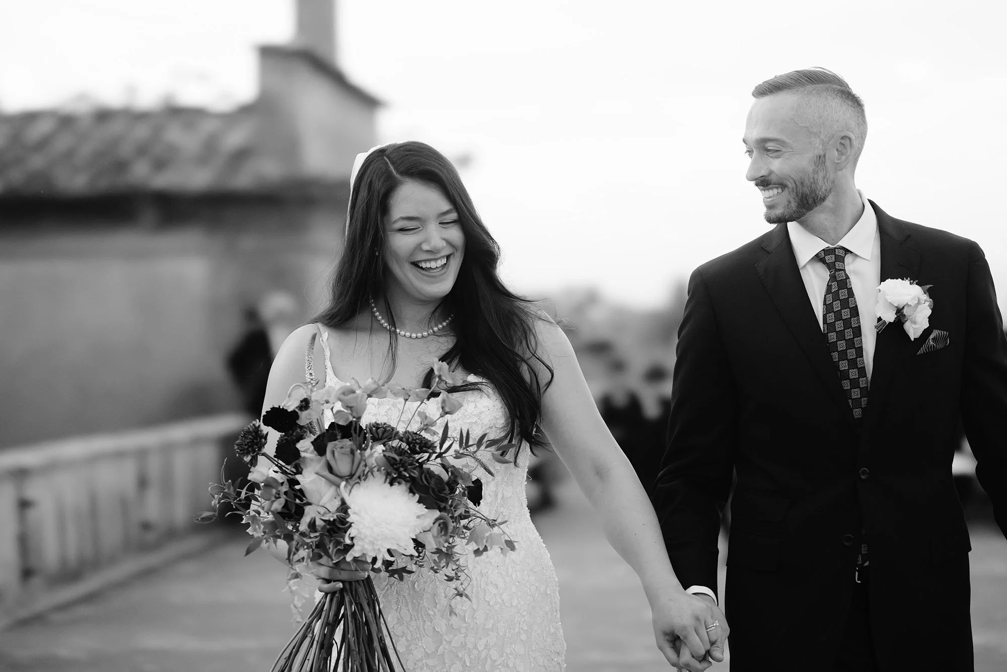 Bride and groom looking happy and emotional while walking away from the ceremony