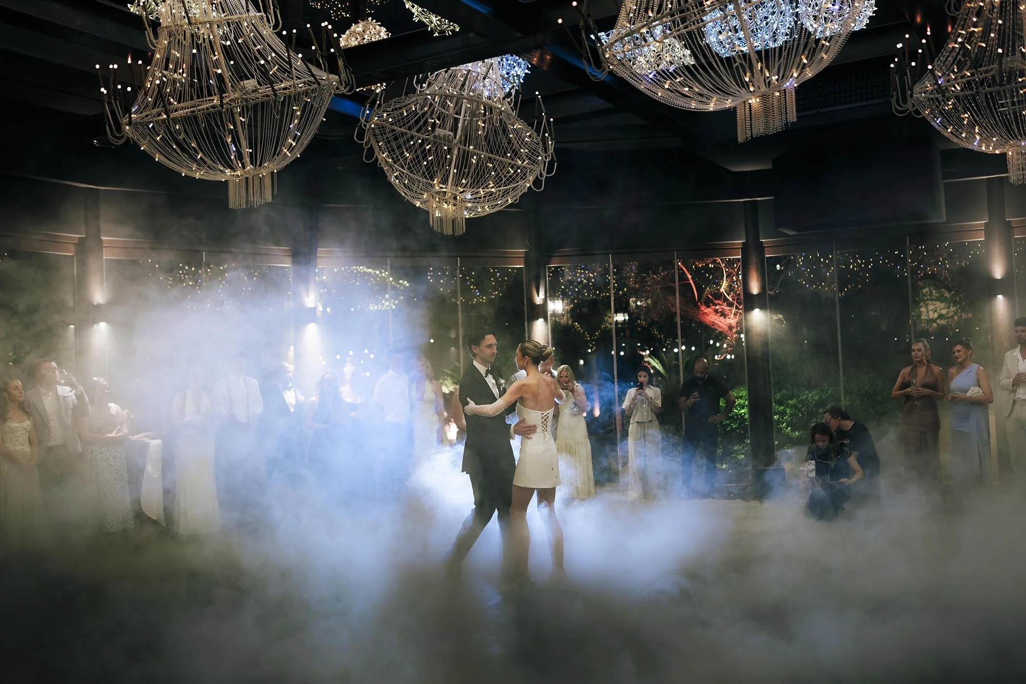 first dance of bride and groom in the glasshouse at Tenuta Corbinaia with smoke