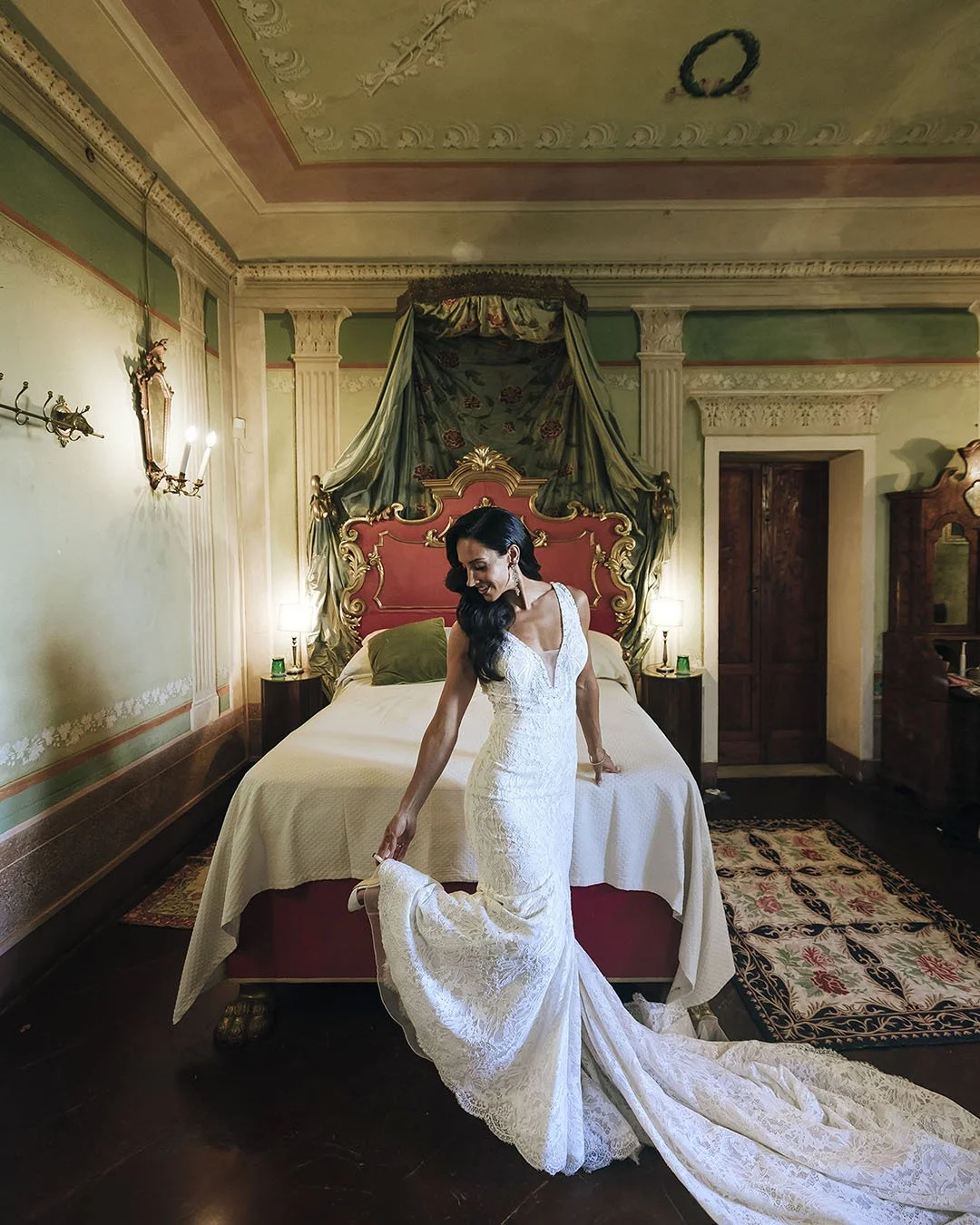 Bride fixing her shoes in the bridal suite