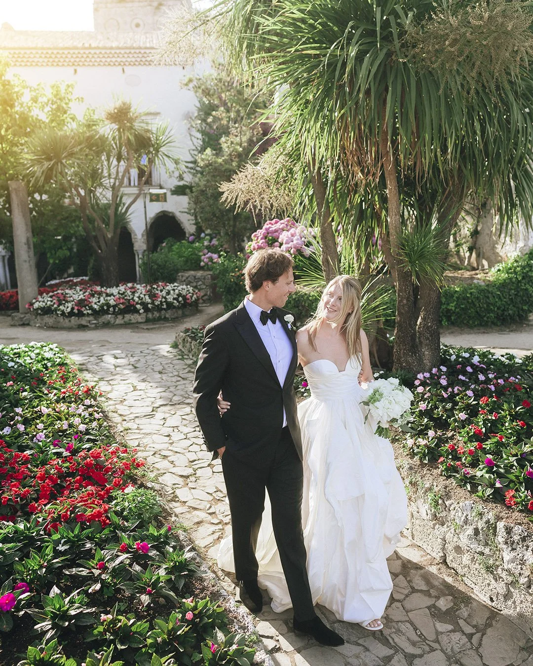bride and groom walking together at the gardens of Villa Rufolo