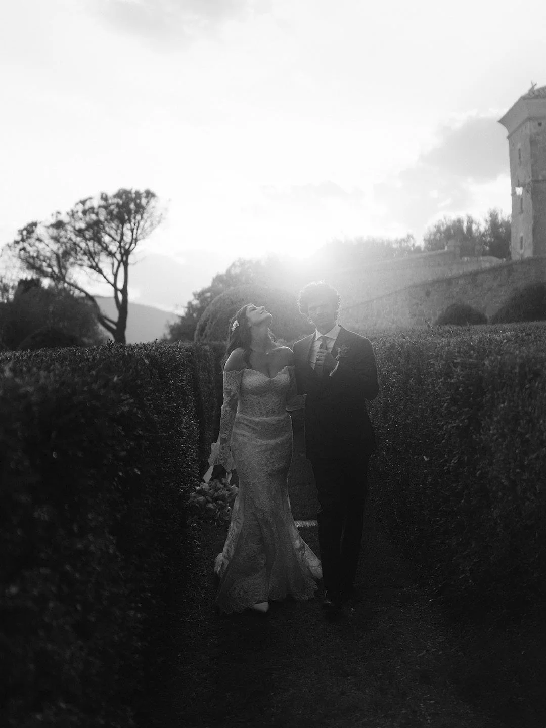 bride and groom walking together at sunset at Castello di Solfagnano in Umbria
