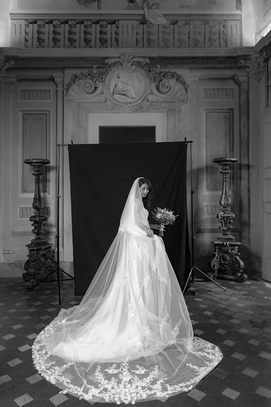 Destination wedding at Castello di Montegufoni in Florence, photo by Rellini art studio documentary wedding photographers in Tuscany. Bride in her dress looking like a model from a fashion magazine