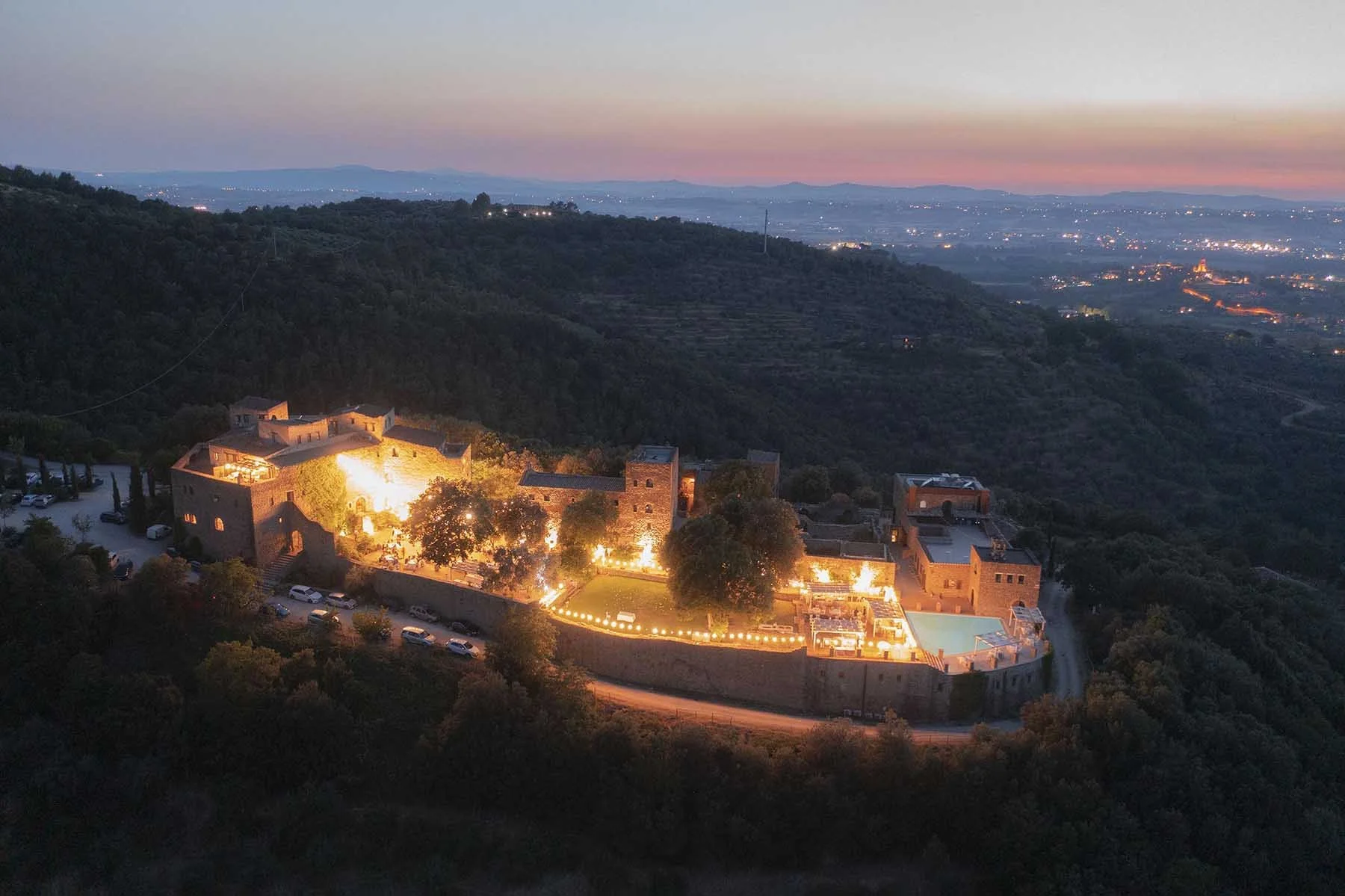 aerial view of Castello di Rosciano by night with Umbria hills in the background
