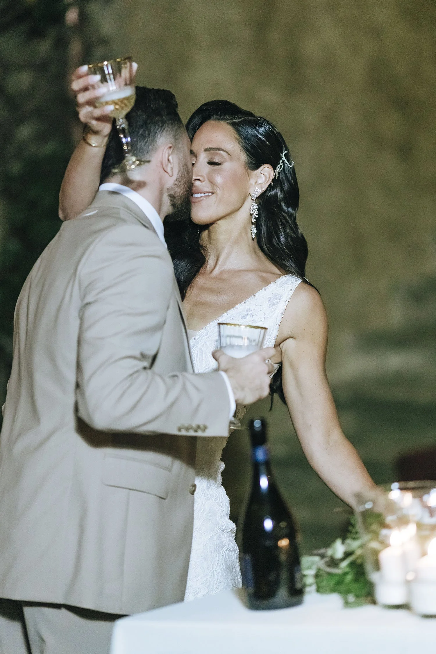 bride and groom kiss after cutting the cake