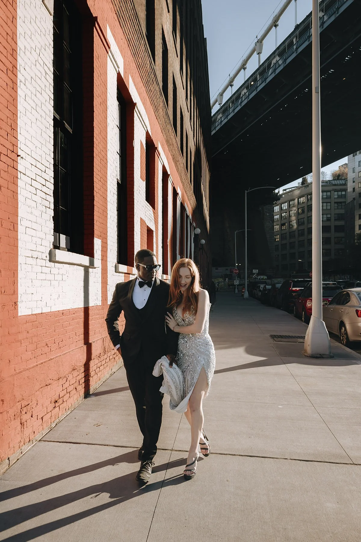 bride and groom walking together under the Manhattan bride in New York