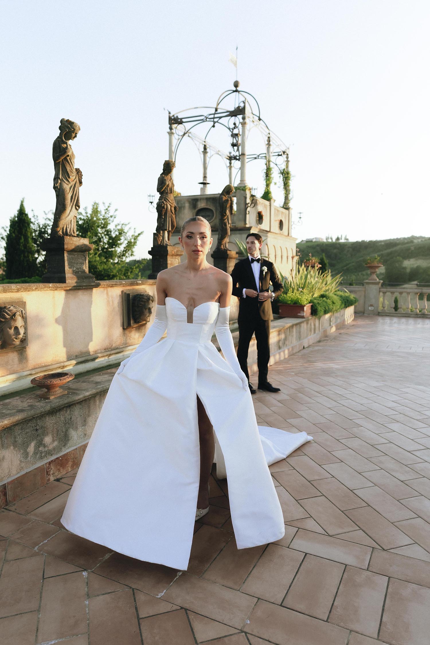 The bride and the groom on the terrace at Tenuta Corbinaia looking into te sunset