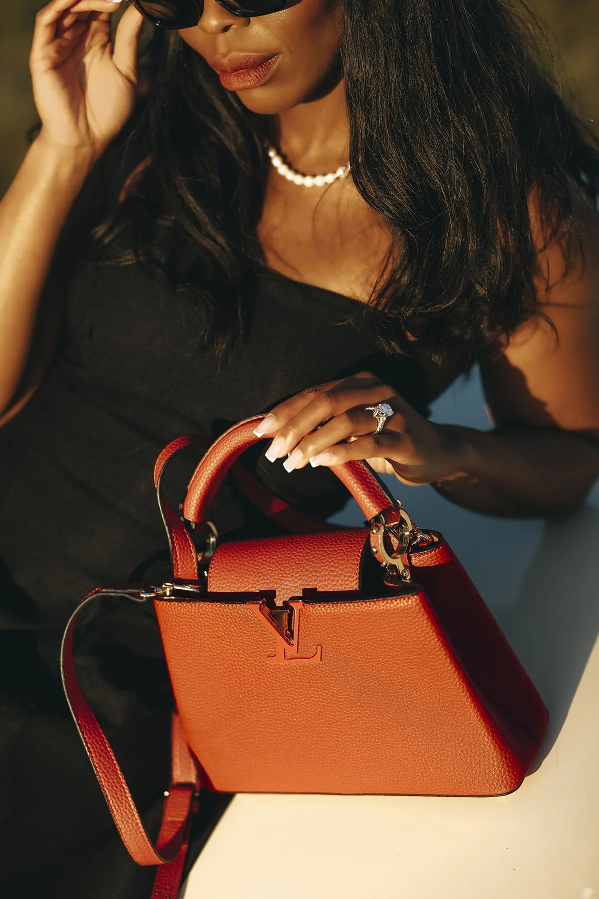 Magazine style photo of a bride with her luxury bag. photo by Rellini art studio, destination wedding photographers in Amalfi coast