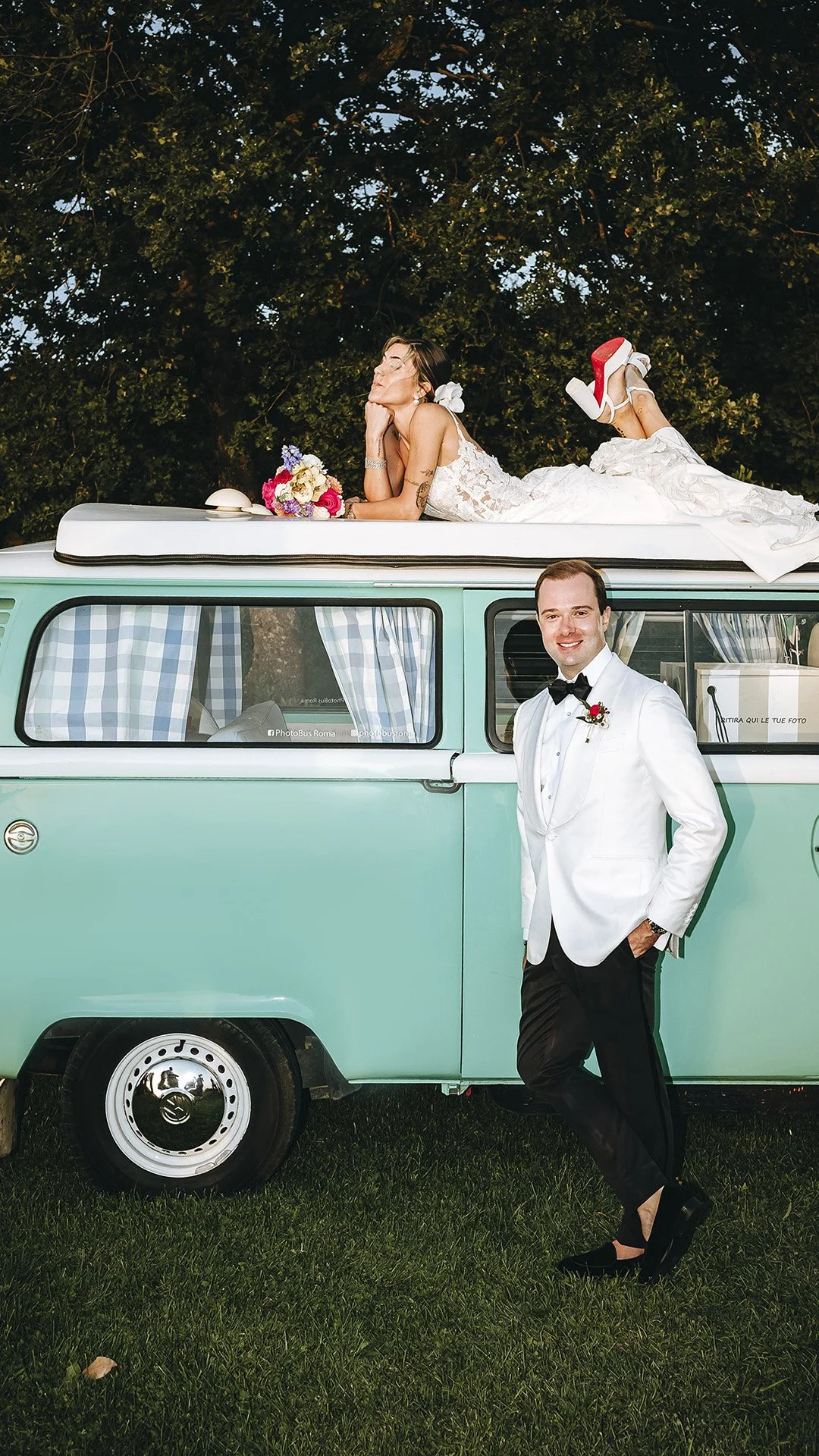Bride on top of a van and groom looking into the sunset