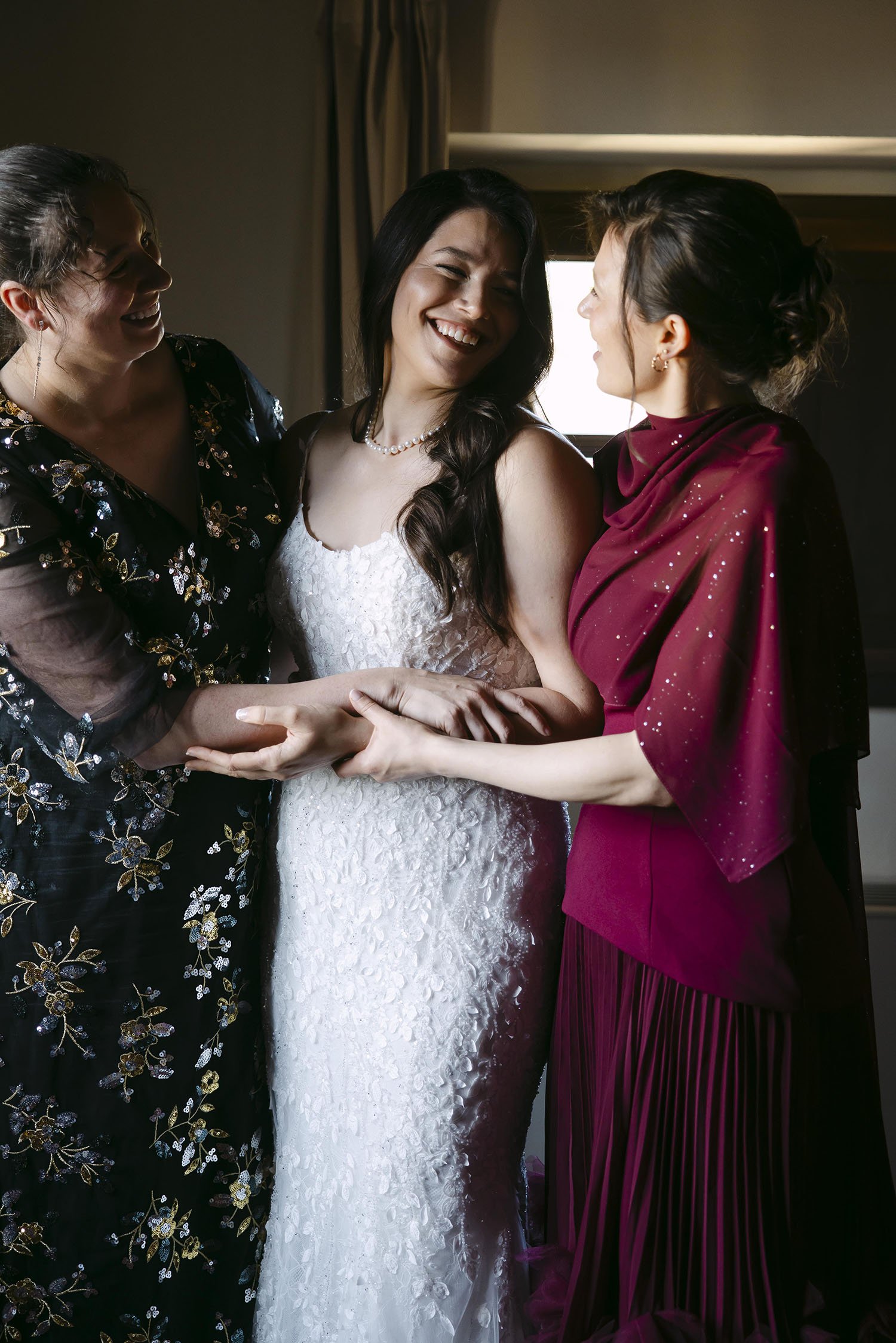 Bride hugging her sisters 