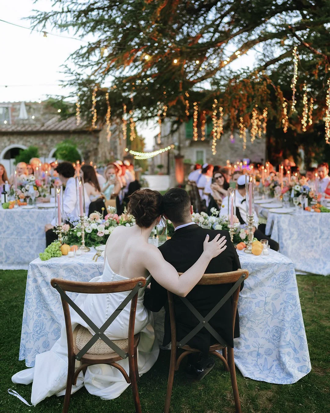 Bride and groom next to each other sitting at the dinner table
