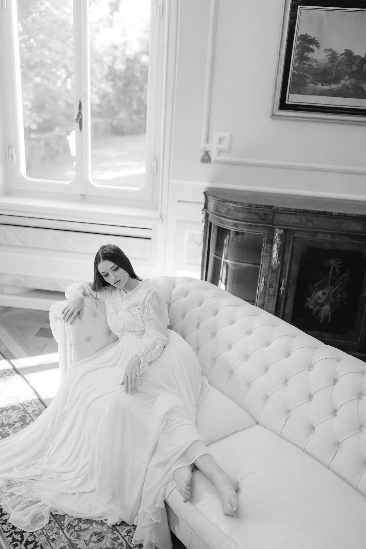 A classy bride in her underwear on a sofa getting ready before the ceremony in Sorrento. photo by Rellini art studio, destination wedding photographers in Amalfi coast
