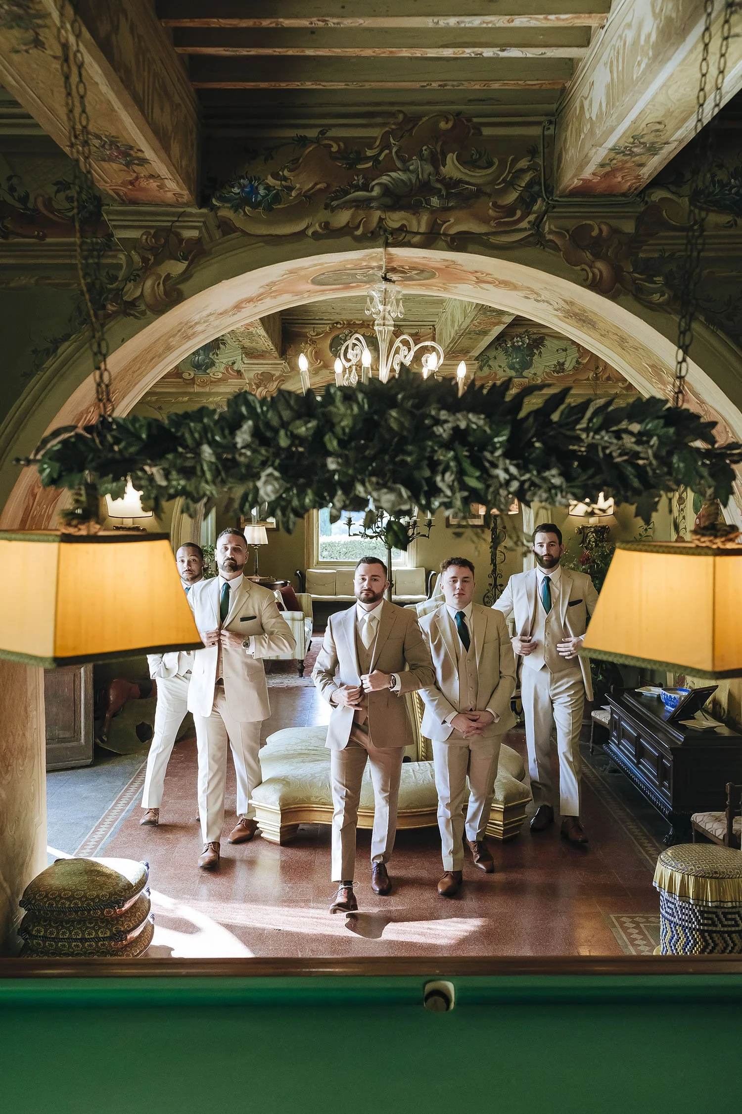 groom portrait with his groomsmen in the billiard room at Borgo Stomennano