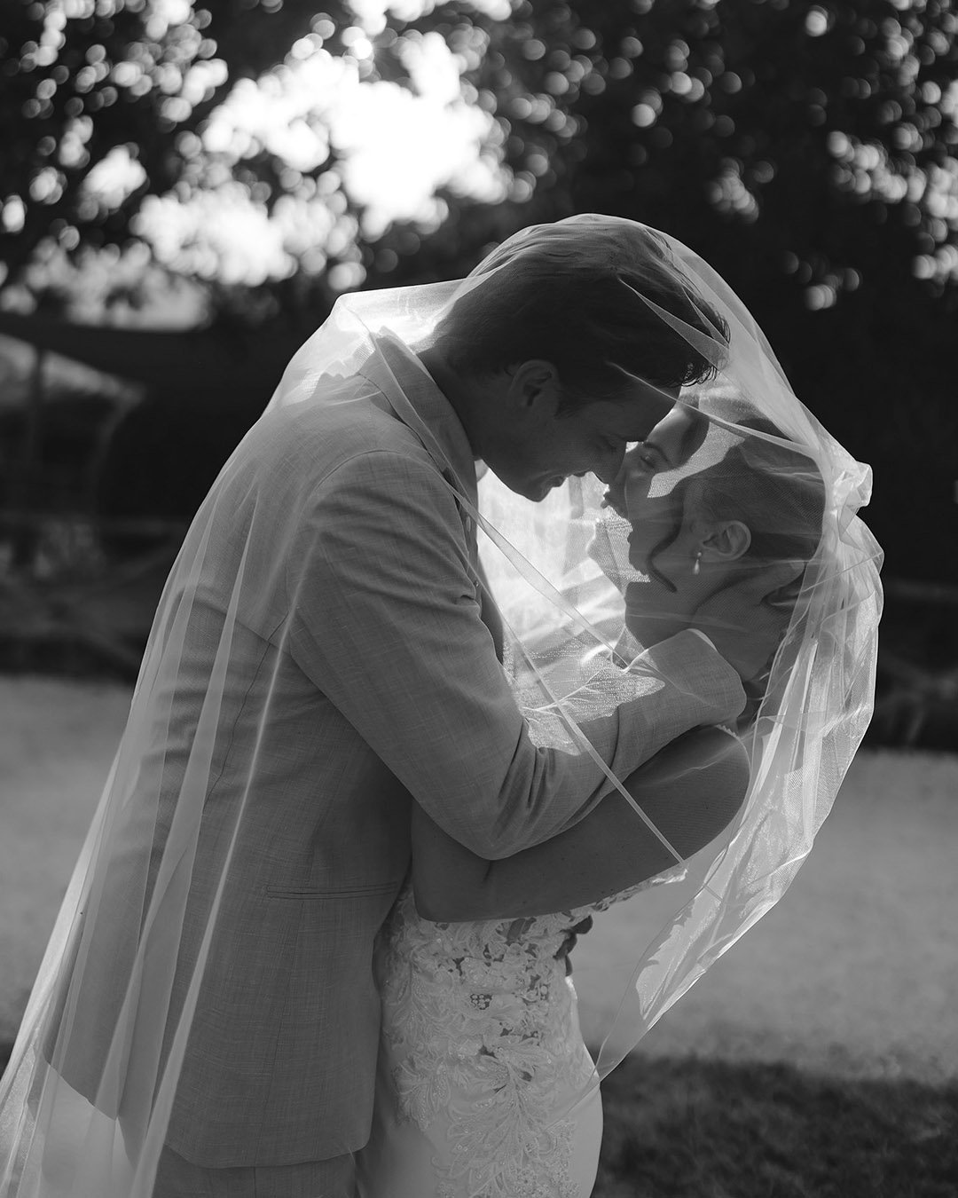 groom and bride kiss each other under the veil at Borgo Castello Panicaglia