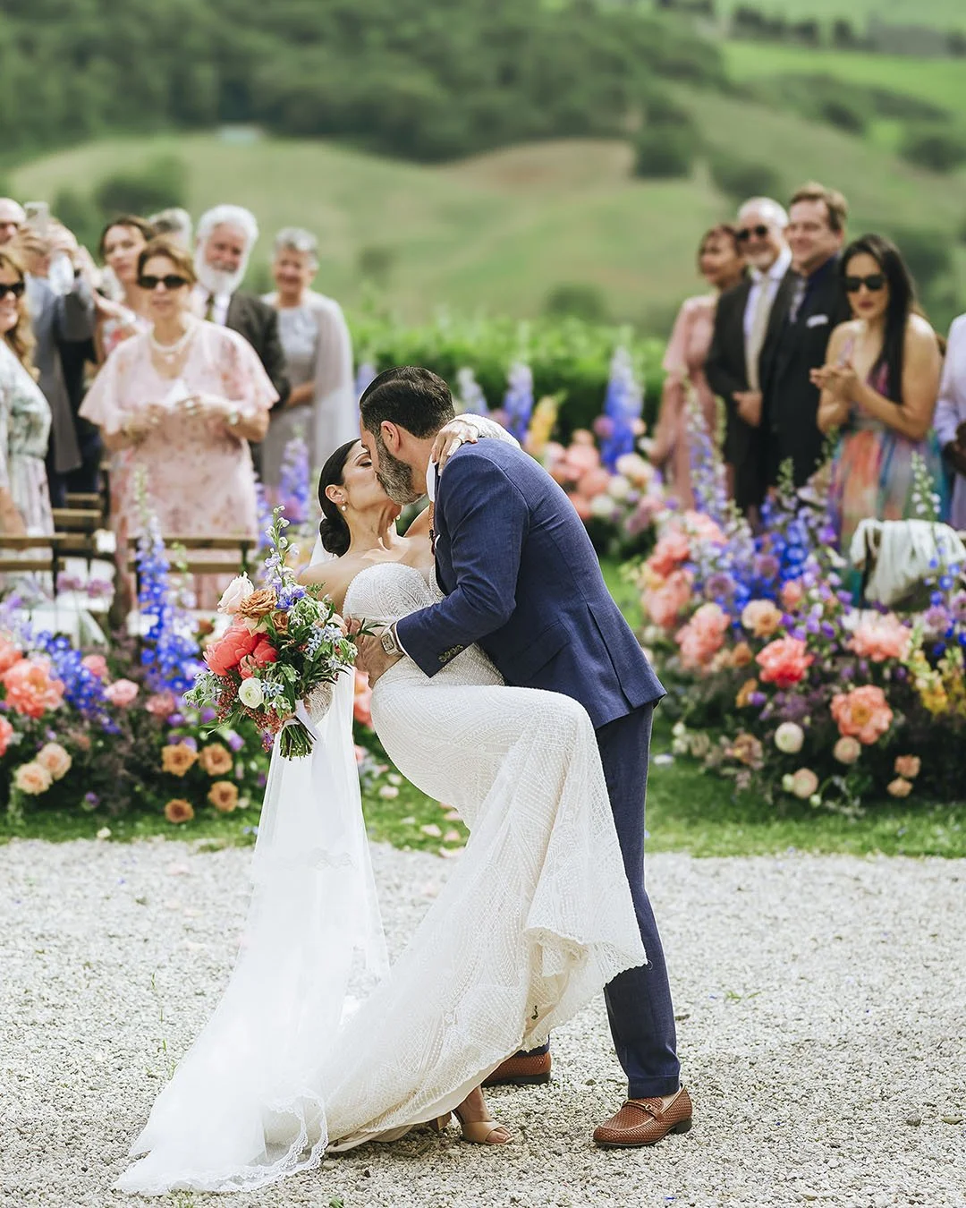 bride and groom kiss down the aisle