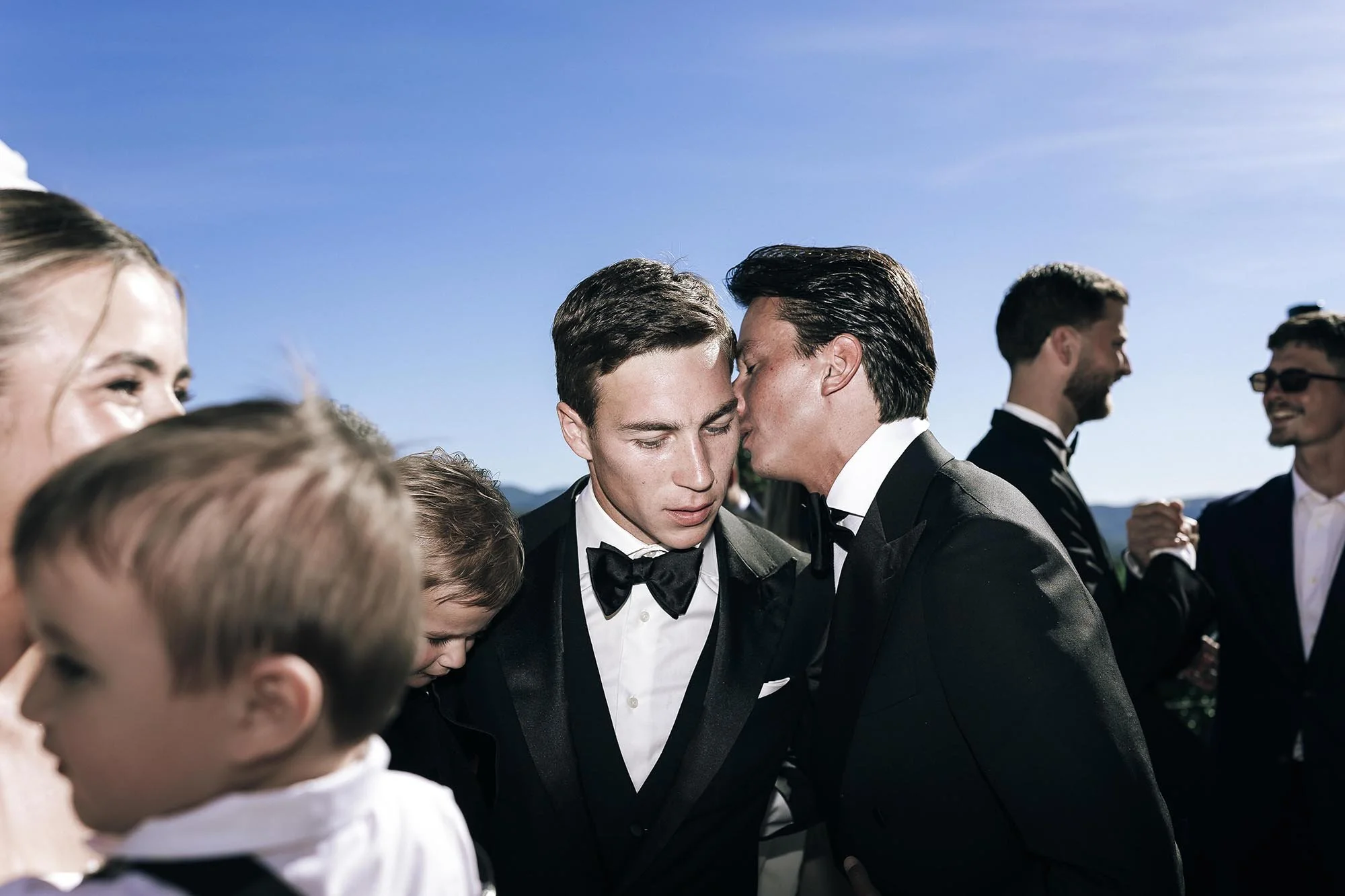 guests celebrating the couple kissing and holding them