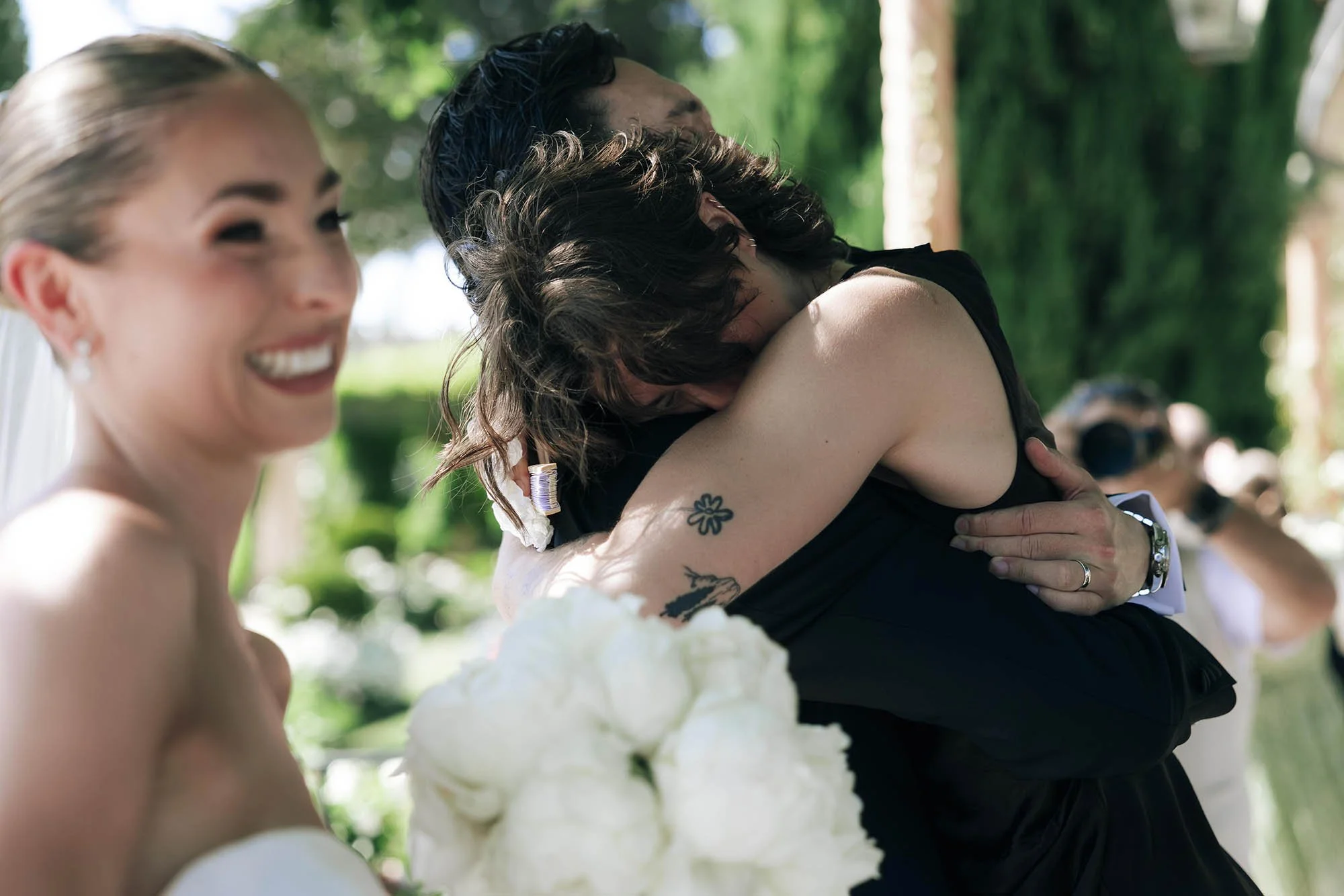 guests approach bride and groom to hug kiss and celebrate