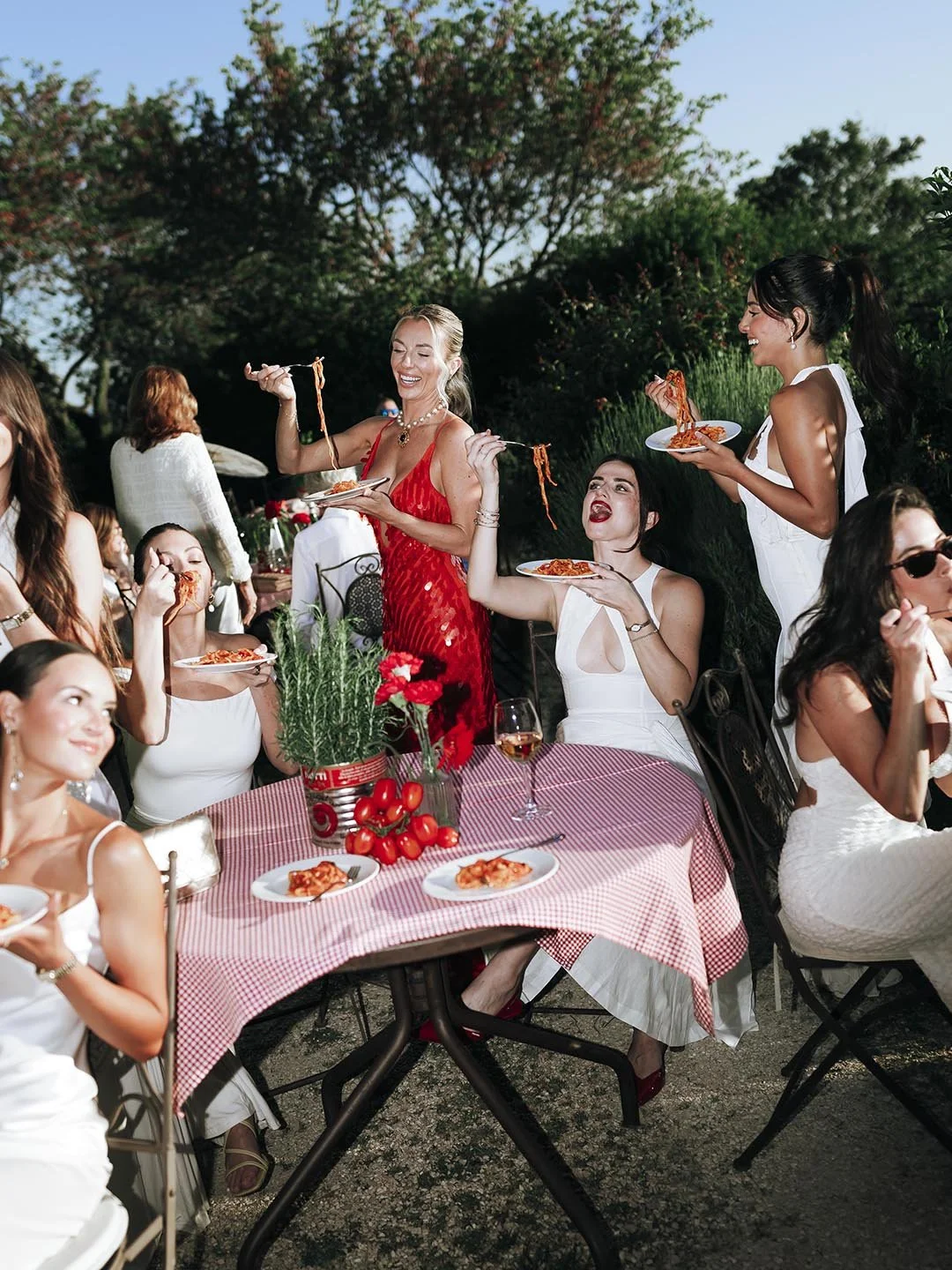 editorial style photo of bride eating pasta with her bridesmaids at Castello di Petrata