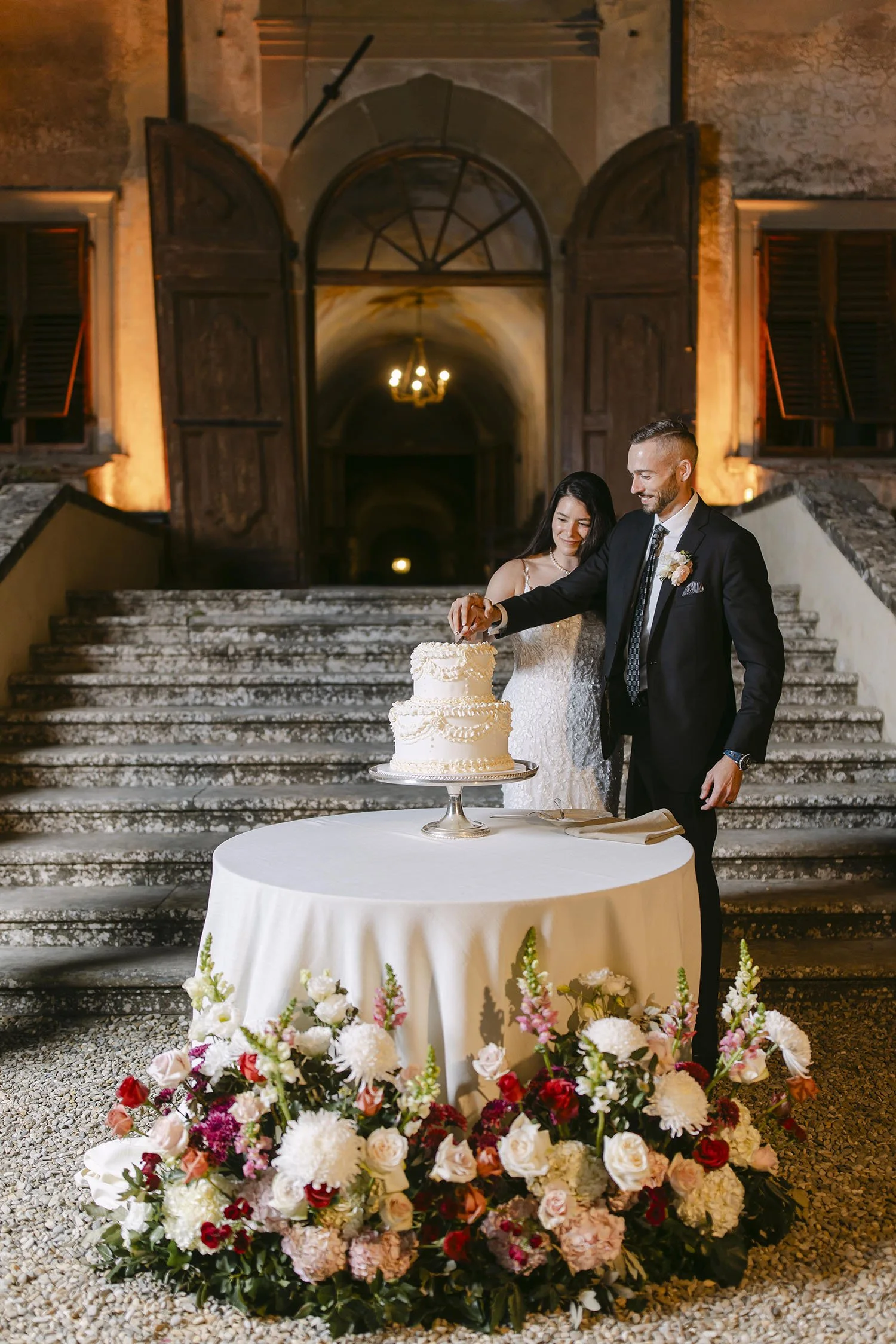 Bride and groom cutting the cake in front of the stairs