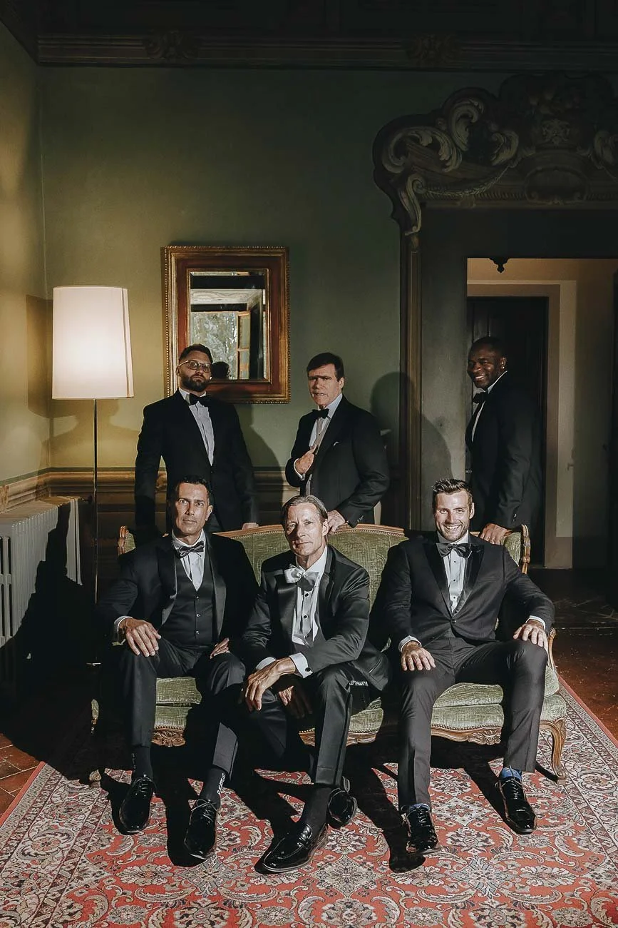 Destination wedding at Castello di Montegufoni in Florence, photo by Rellini art studio documentary wedding photographers in Tuscany. The groom with his groomsmen posed photo with magazine editorial touch