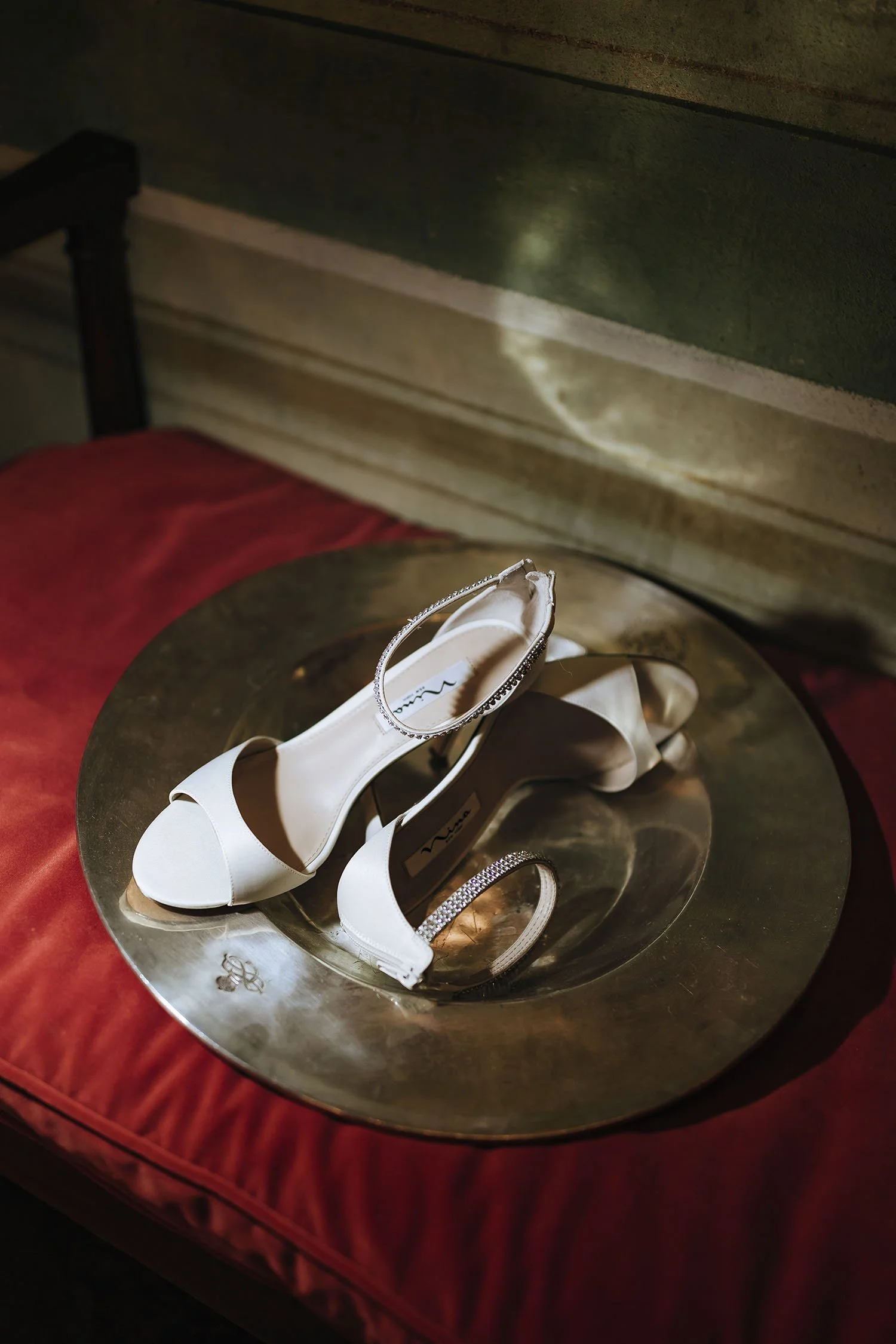 artistic photo of the bride shoes on a silver plate