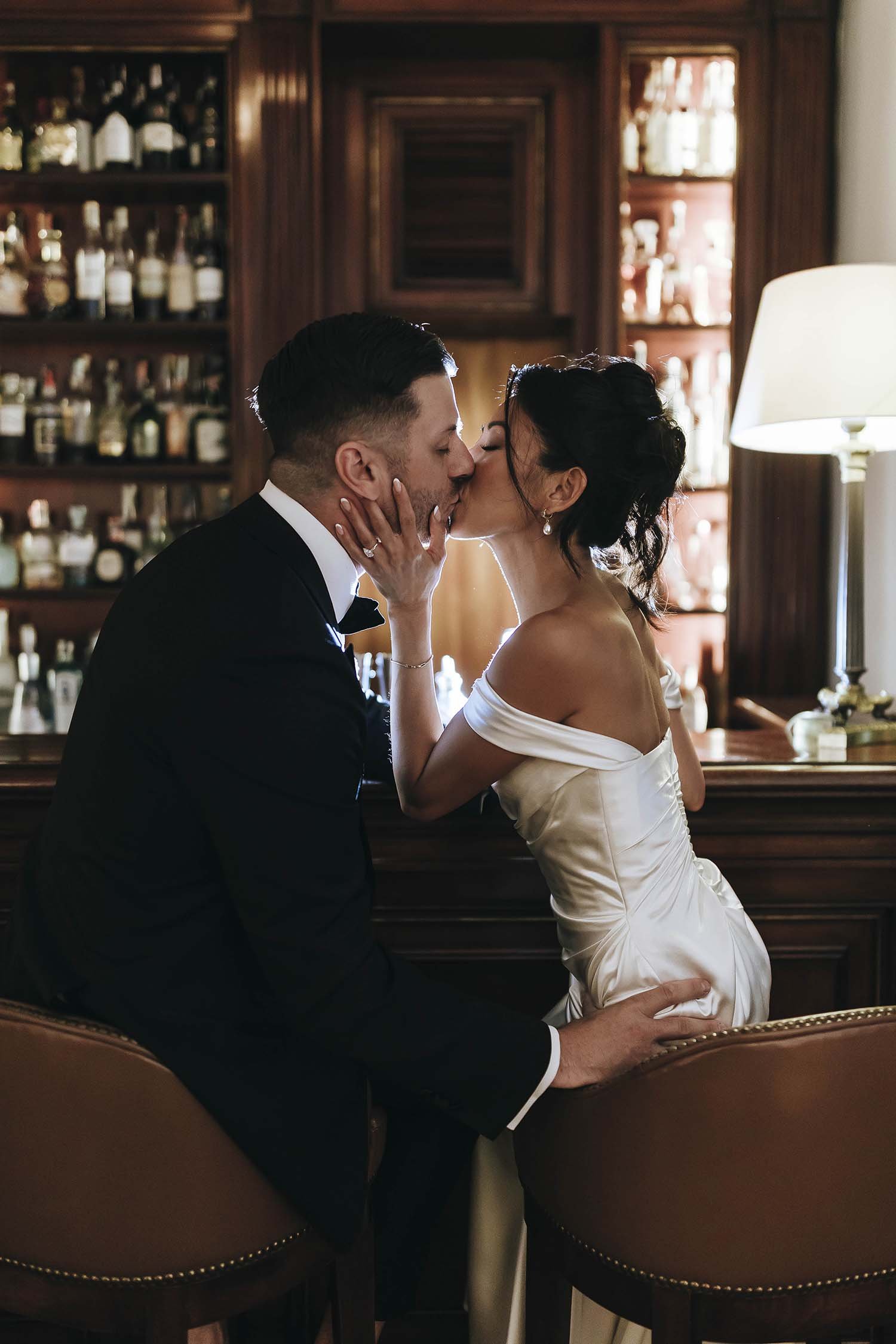 Romantic kiss of bride and groom at the bar of Hotel Caruso a Belmond Hotel. Photo by Rellini art studio destination wedding photographer in Amalfi