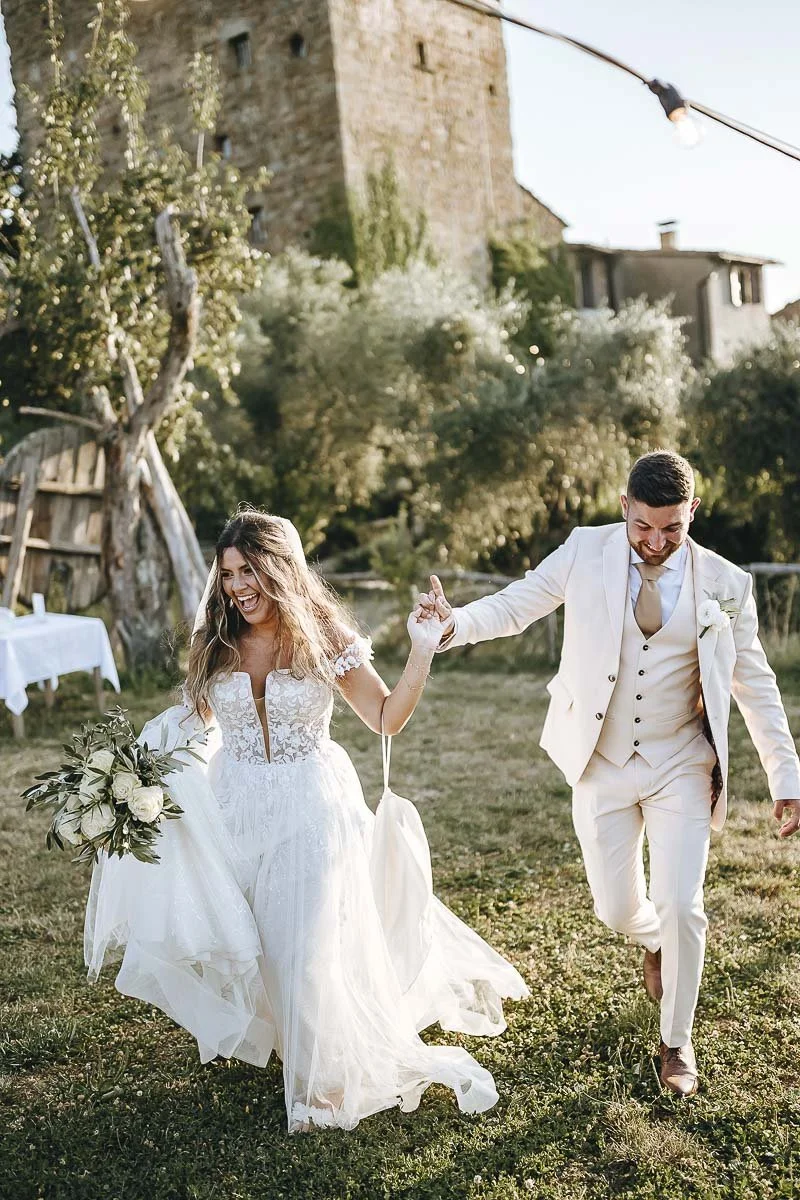 Destination wedding at Ristonchi castle near Florence in Tuscany. bride and groom approaching the cocktail dancing to the music