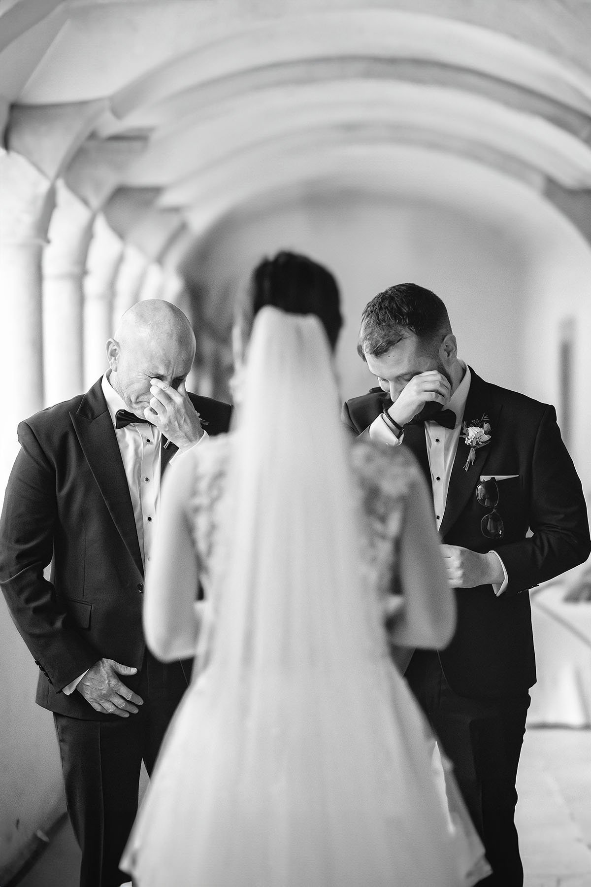Documentary moments of the first kiss of the bride with her father and brother by Rellini art studio, best wedding photographers in Italy