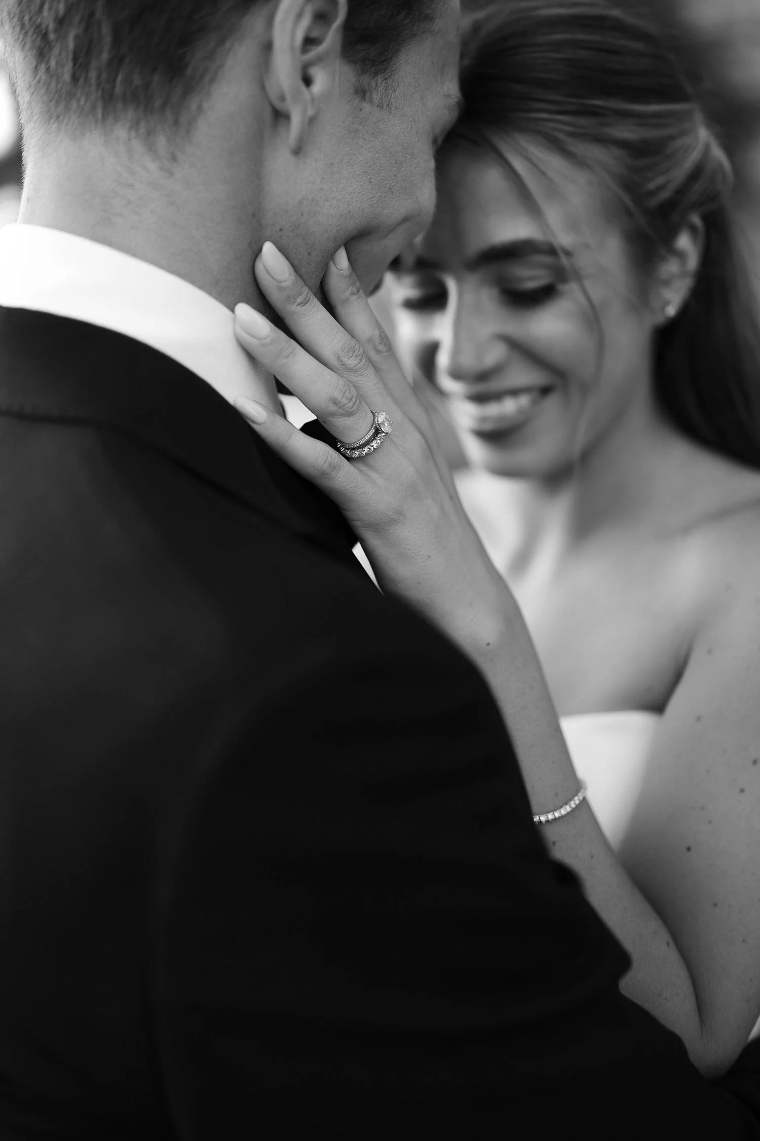 bride hodling te groom and closing her eyes