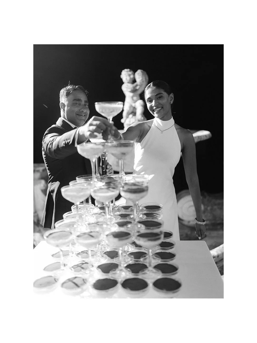 bride and groom taking classes from a Tiramisu tower at Torre di Pila in Umbria