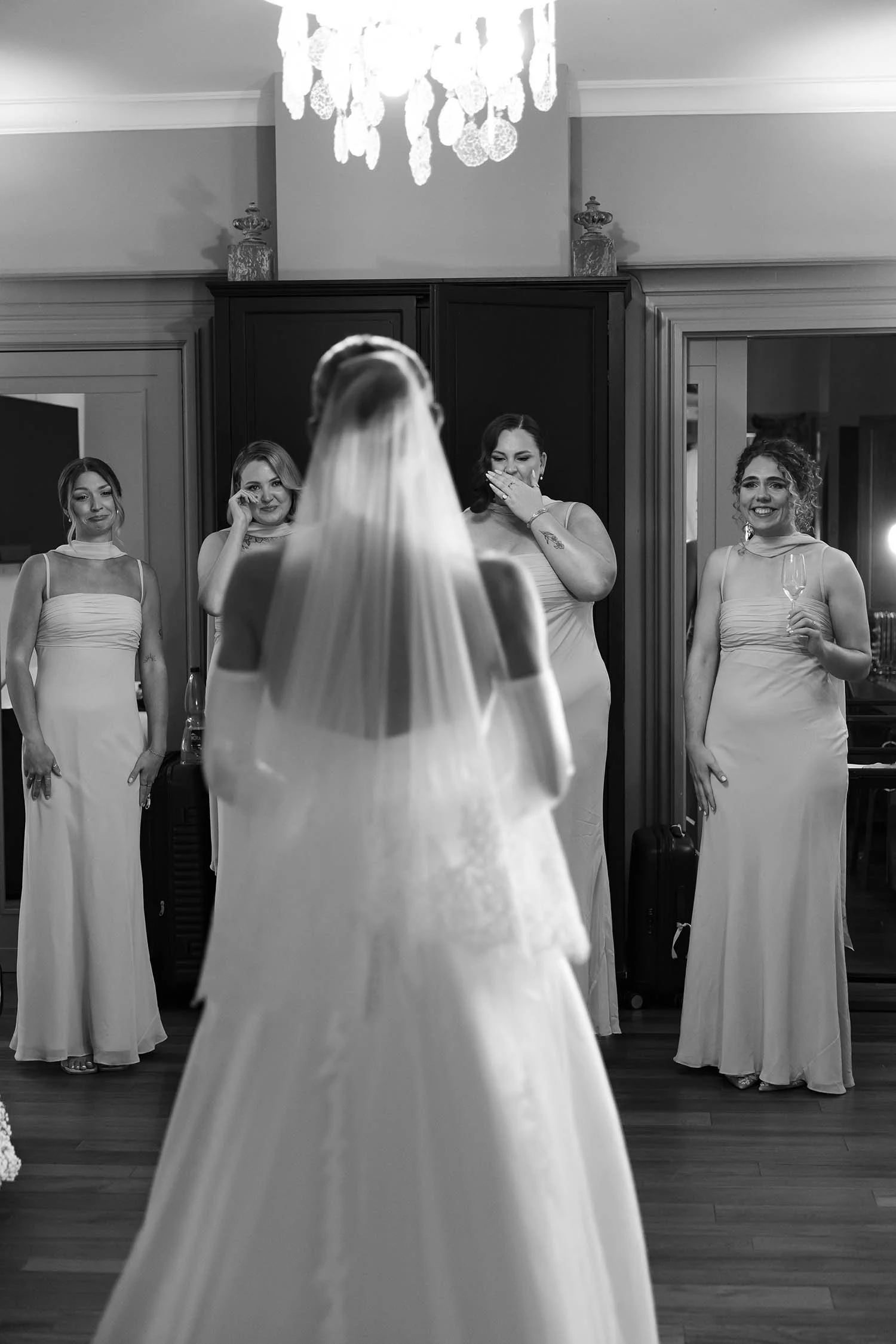 First look of the bride with her bridesmaids in the bridal suite