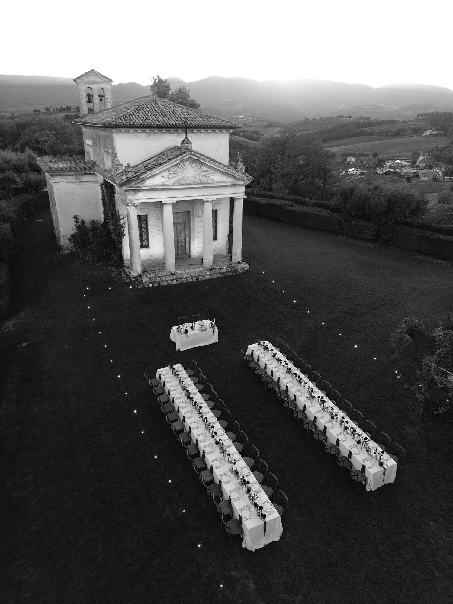 aerial view of a tuscan villa with the table setting at sunset. photo by Rellini art studio