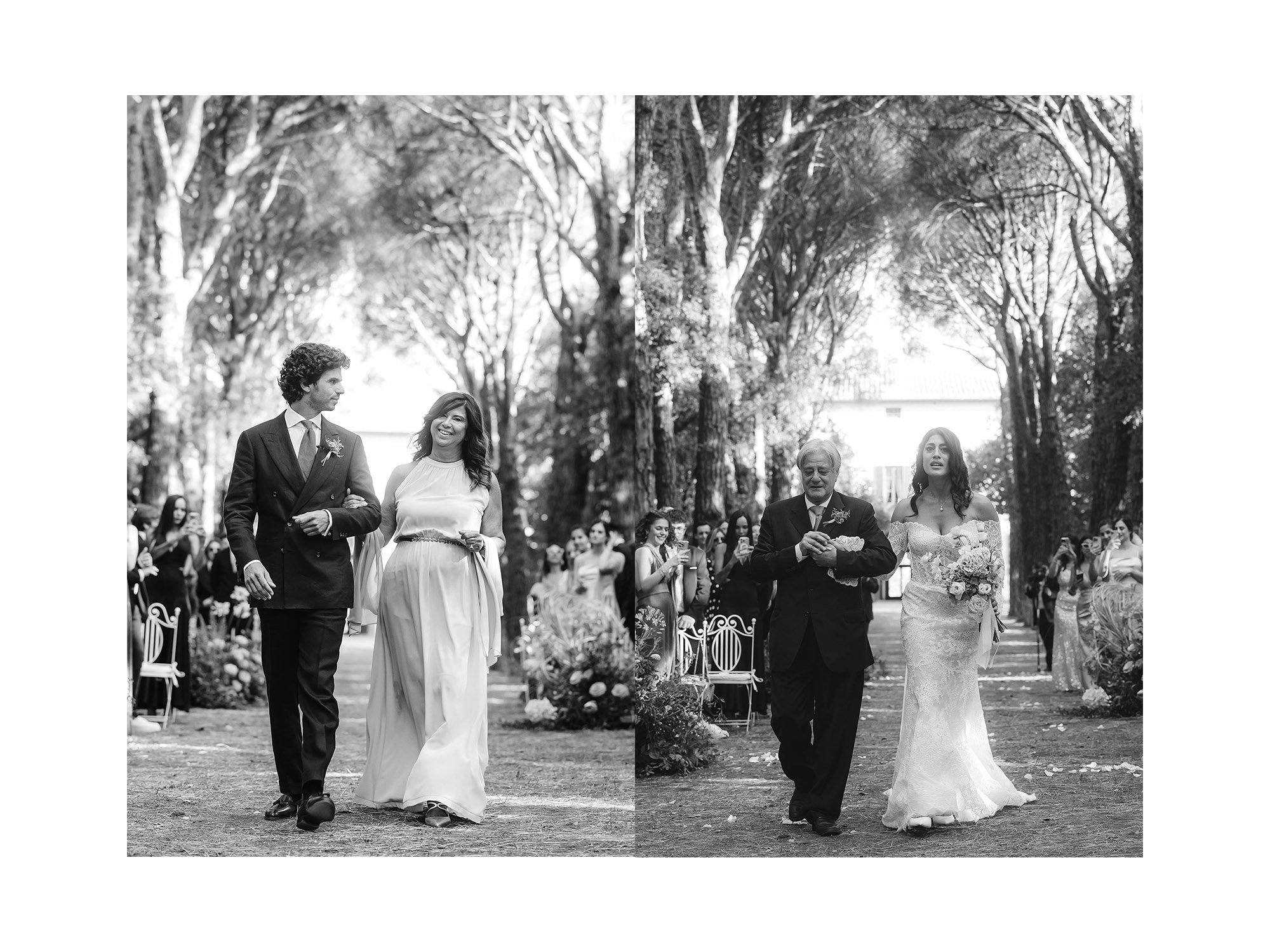 Black and white photo of a wedding ceremony outdoors with guests seated on either side. The bride, in a wedding dress, walks with her father on the right, and the groom, in a tuxedo, walks with his mother on the left, all under tall trees.