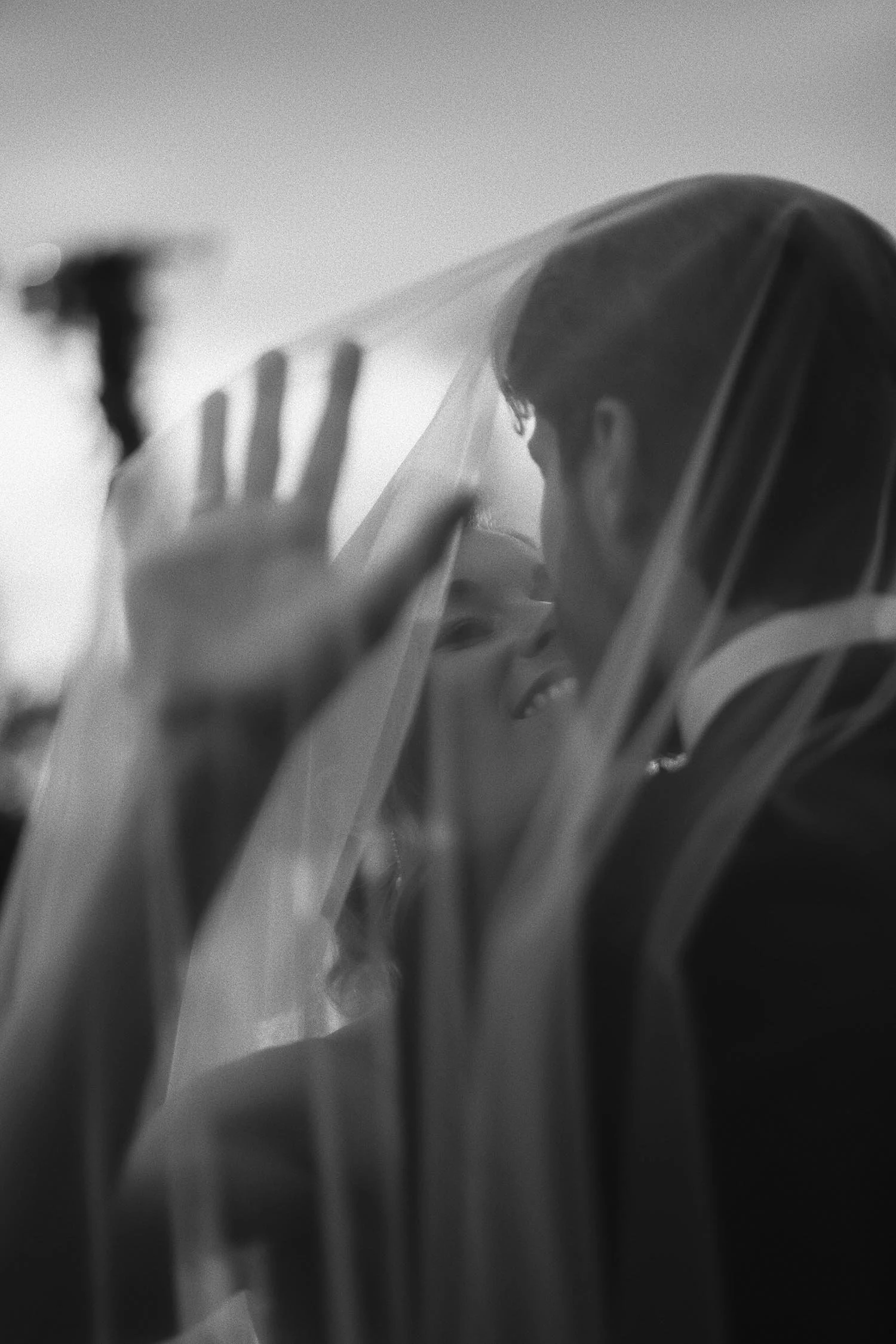 Bride and groom kiss under the veil at Castello di Petrata at sunset