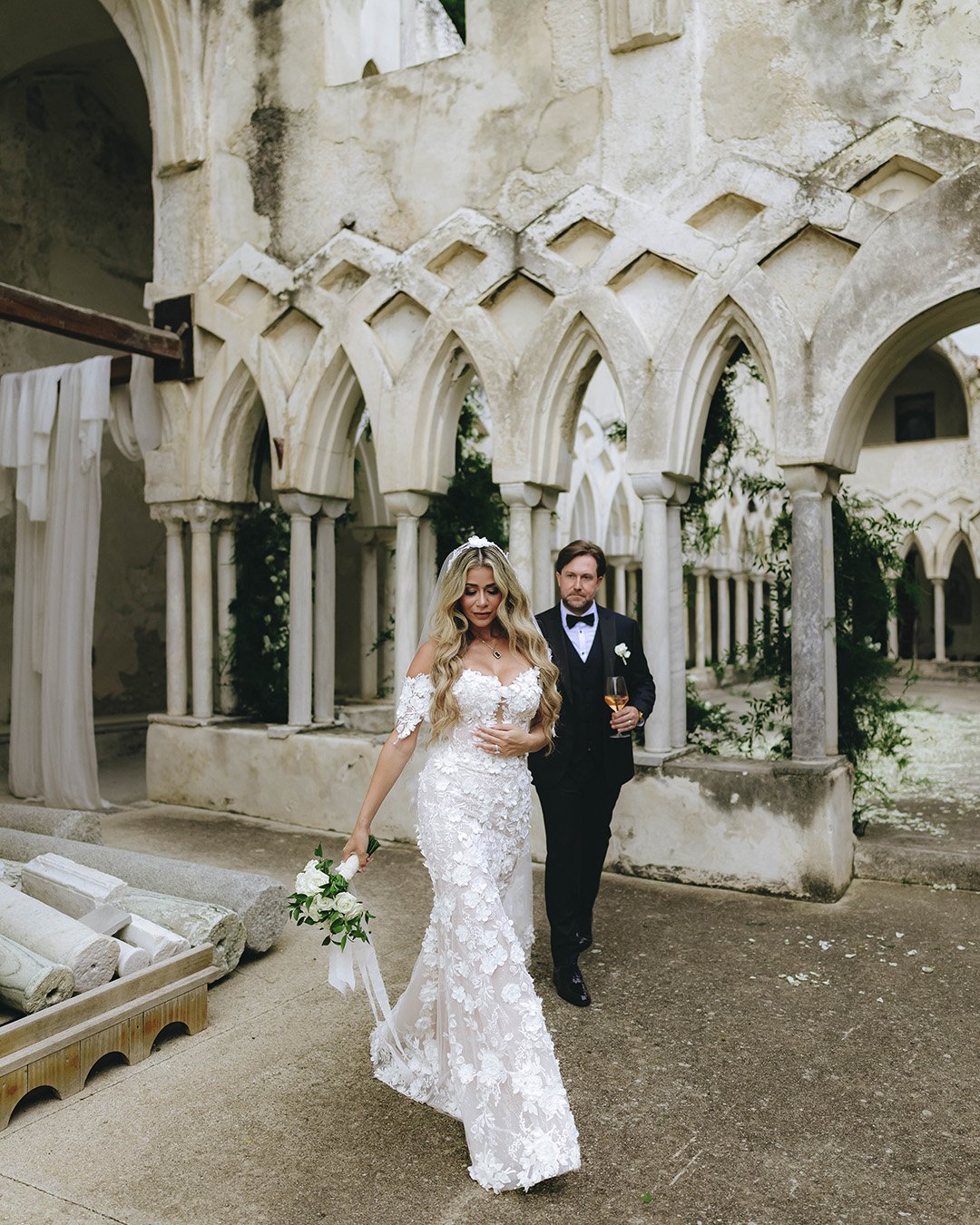 bride and groom walk together at GrandHotel Monastero Anantara in Amalfi