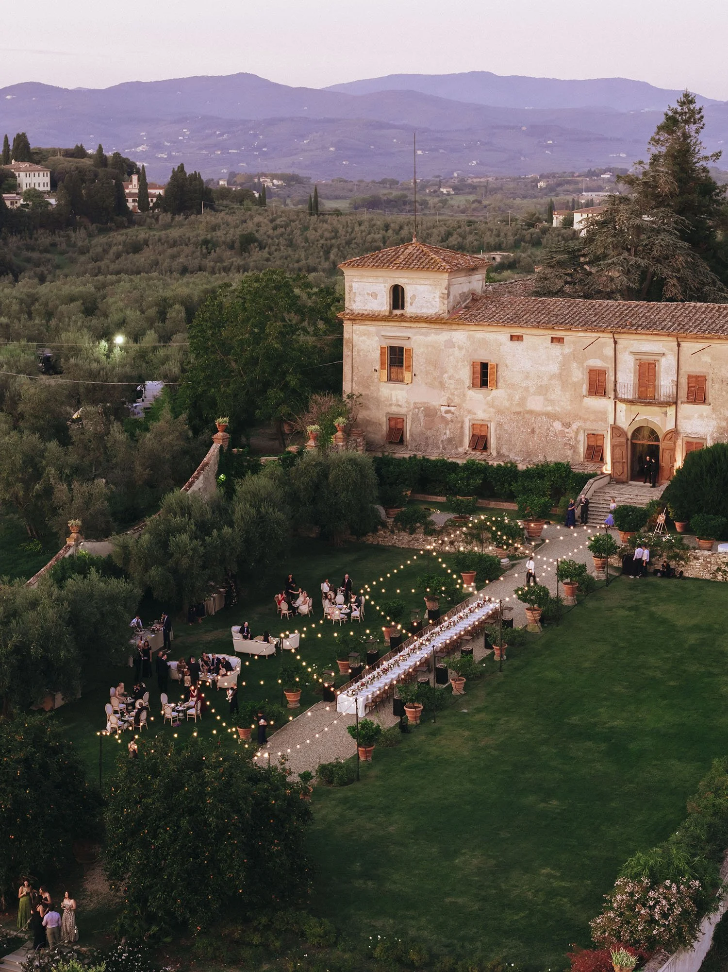 Aerial view of the dinner table at Villa Medicea di Lilliano with a warm sunset