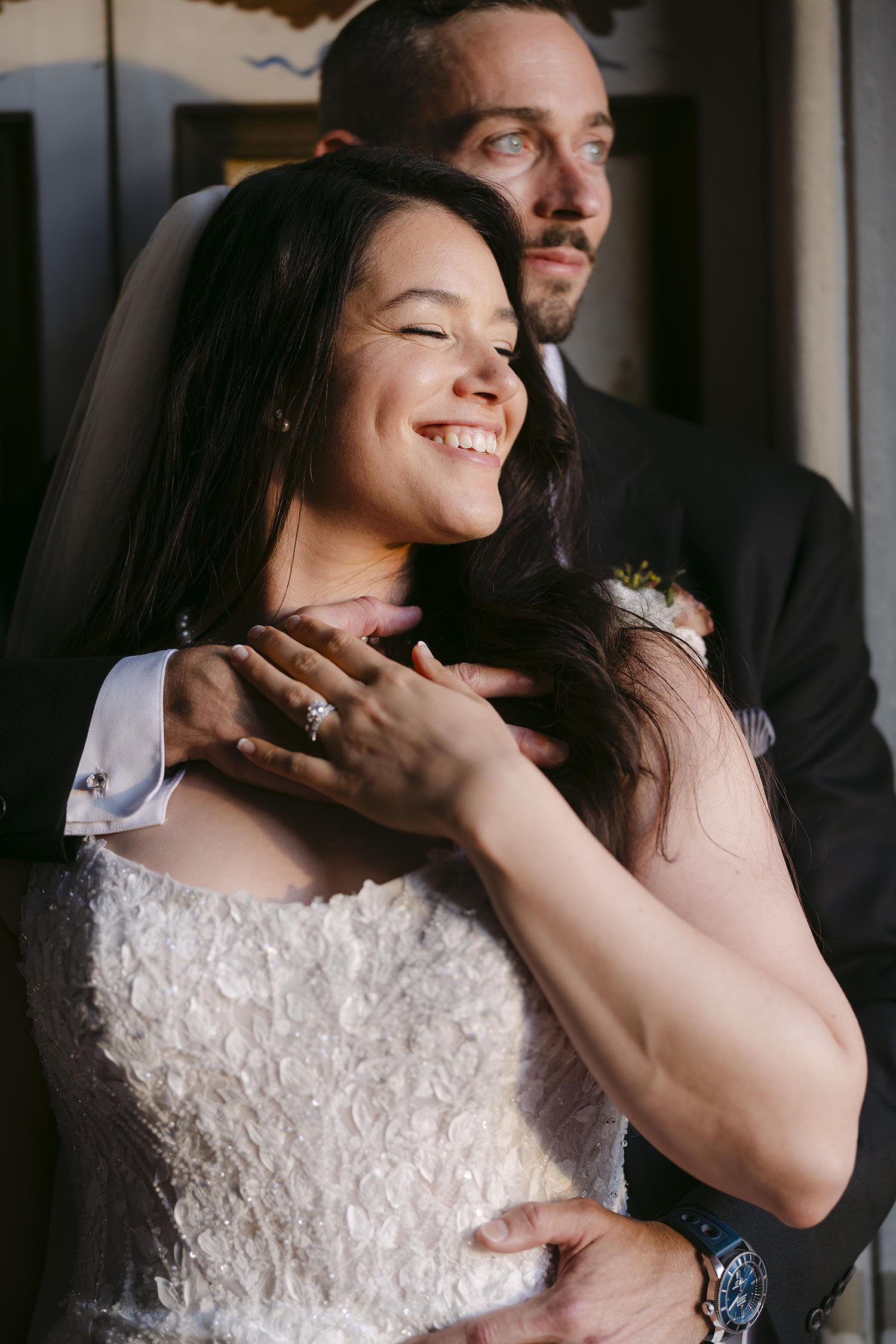 Groom holding the bride in the sunset light
