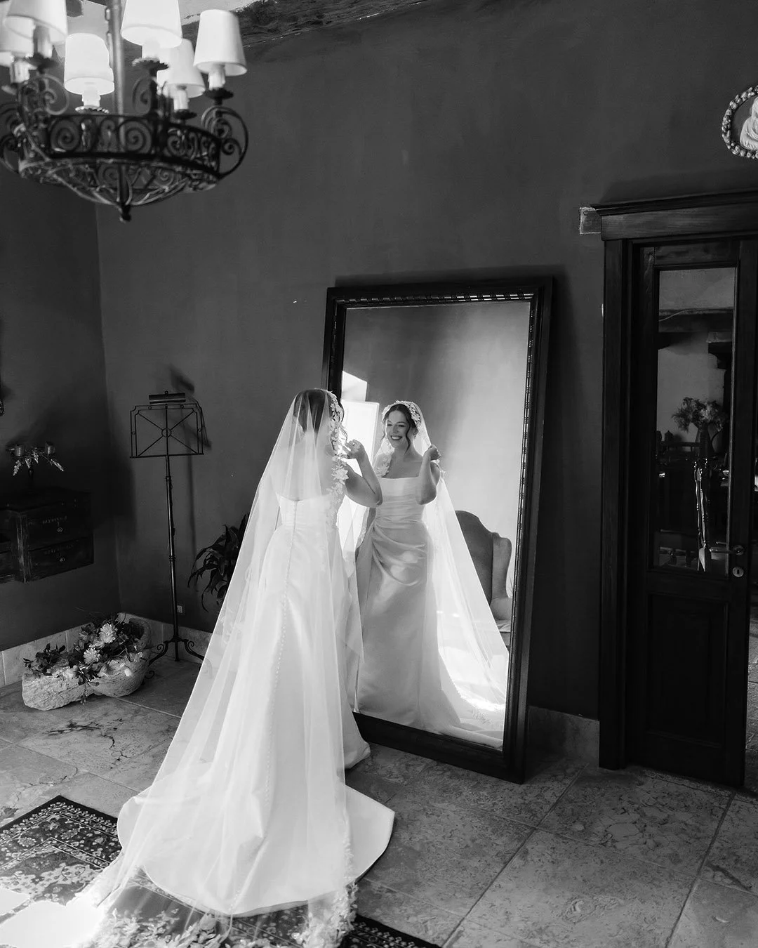 The bride looking herself in the big mirror