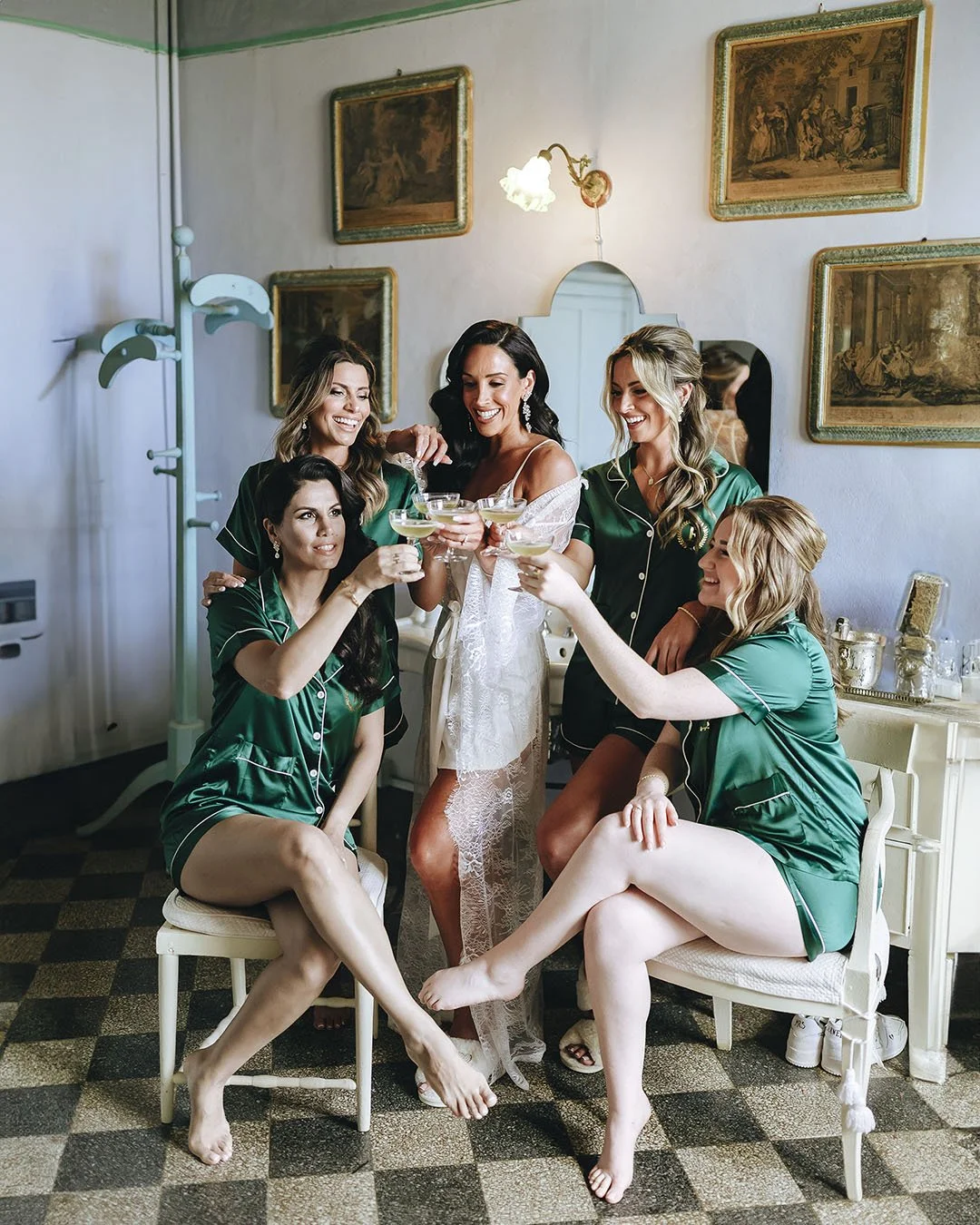 Bride toasting with her bridesmaids in the restroom