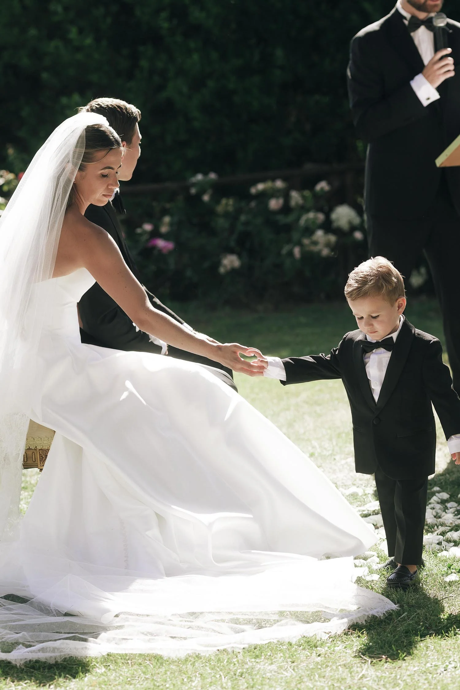 the bride holding the hand of the son during the ceremony