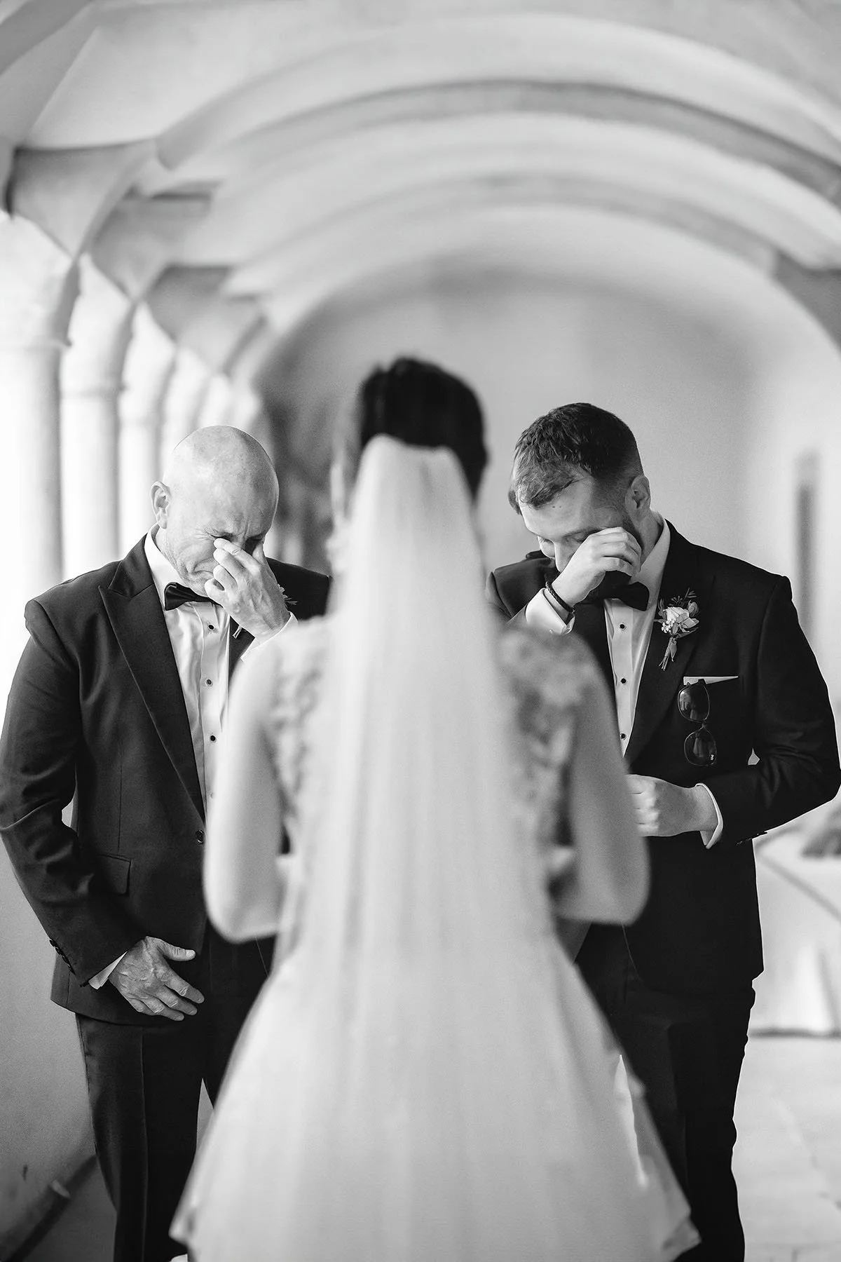 A first look of the bride with her dad and brother at San Pietro in Valley abbey in Umbria. Photo by Rellini art studio documentary and editorial wedding photographers in Umbria