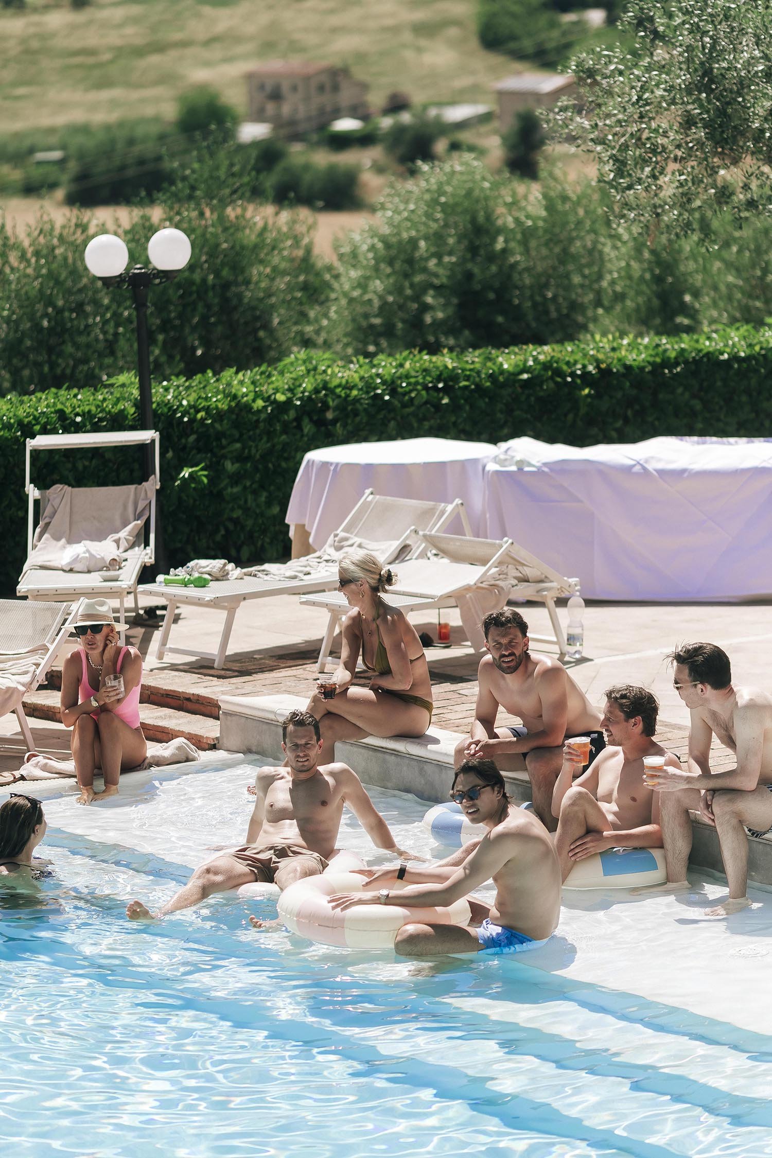 guests relaxing by the pool before the ceremony