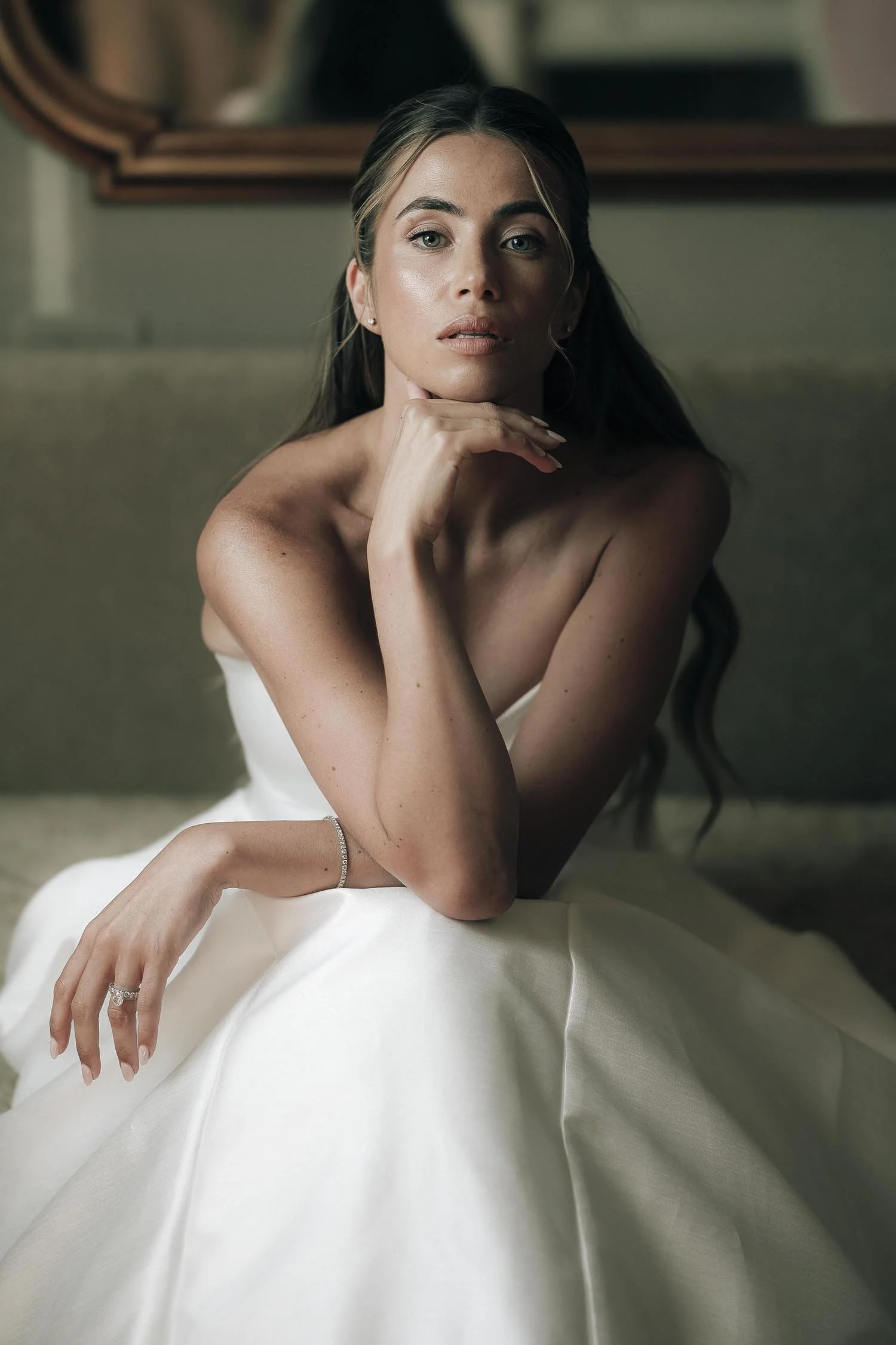 portrait of the bride sitting on the sofa in the bridal suite