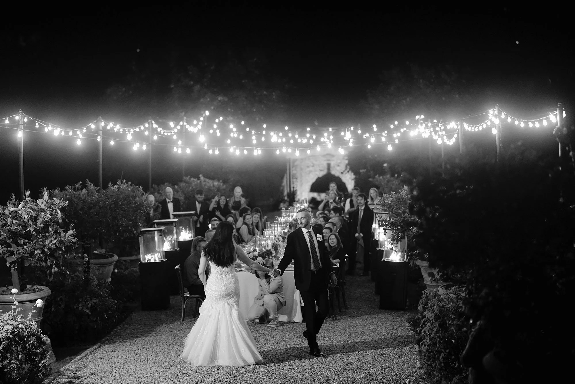The first dance of bride and groom in the main courtyard in front of their guests
