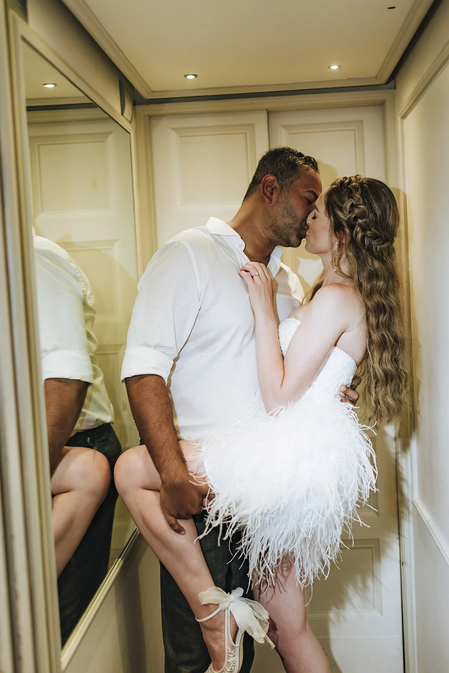 Intimate moment of bride and groom kissing in an elevator at Villa le Fontanelle in Florence