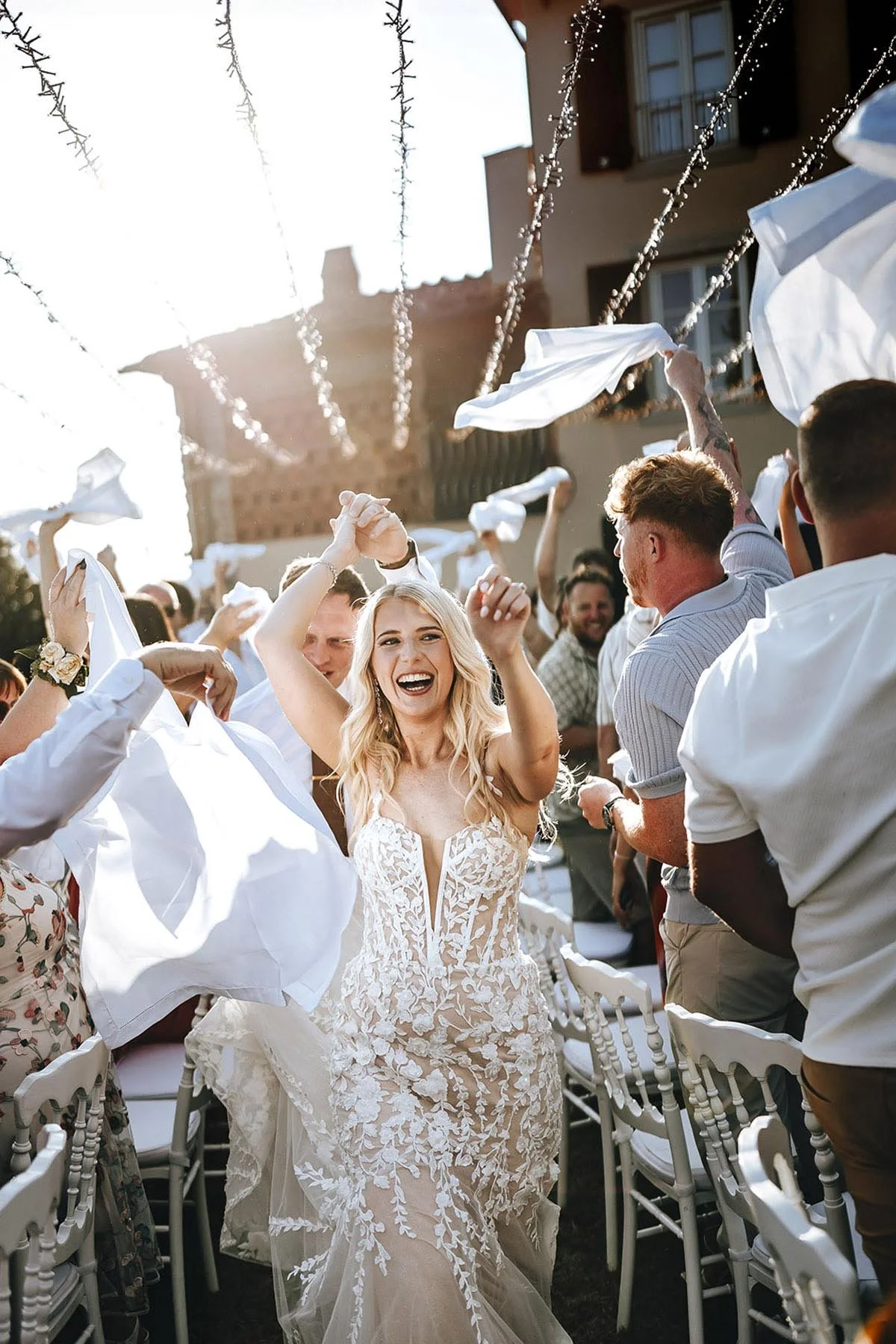 Bride and groom walking to the tables among the guests celebrating them, candid and joyful photo by Rellini art studio