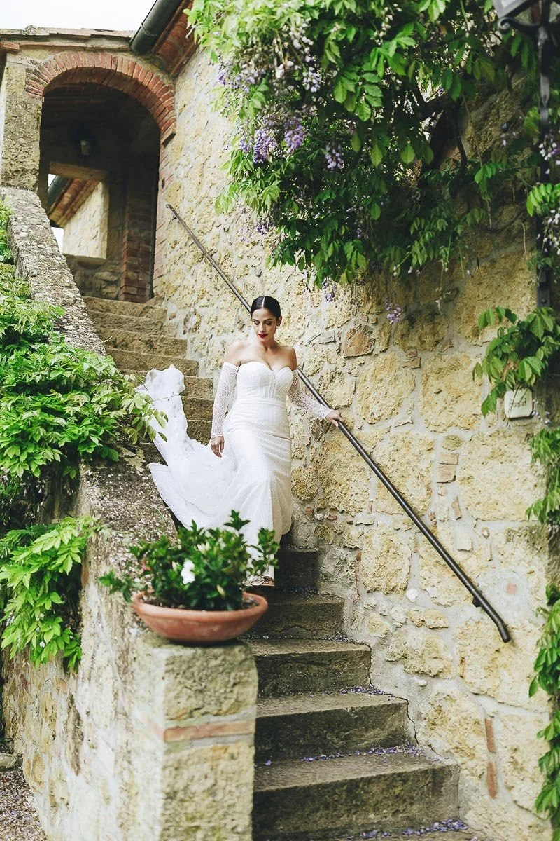 The moments of the ceremony at Terre di Nano wedding venue in Tuscany with the bride walking out of the room. Photo by Rellini art studio award winning married photographers duo