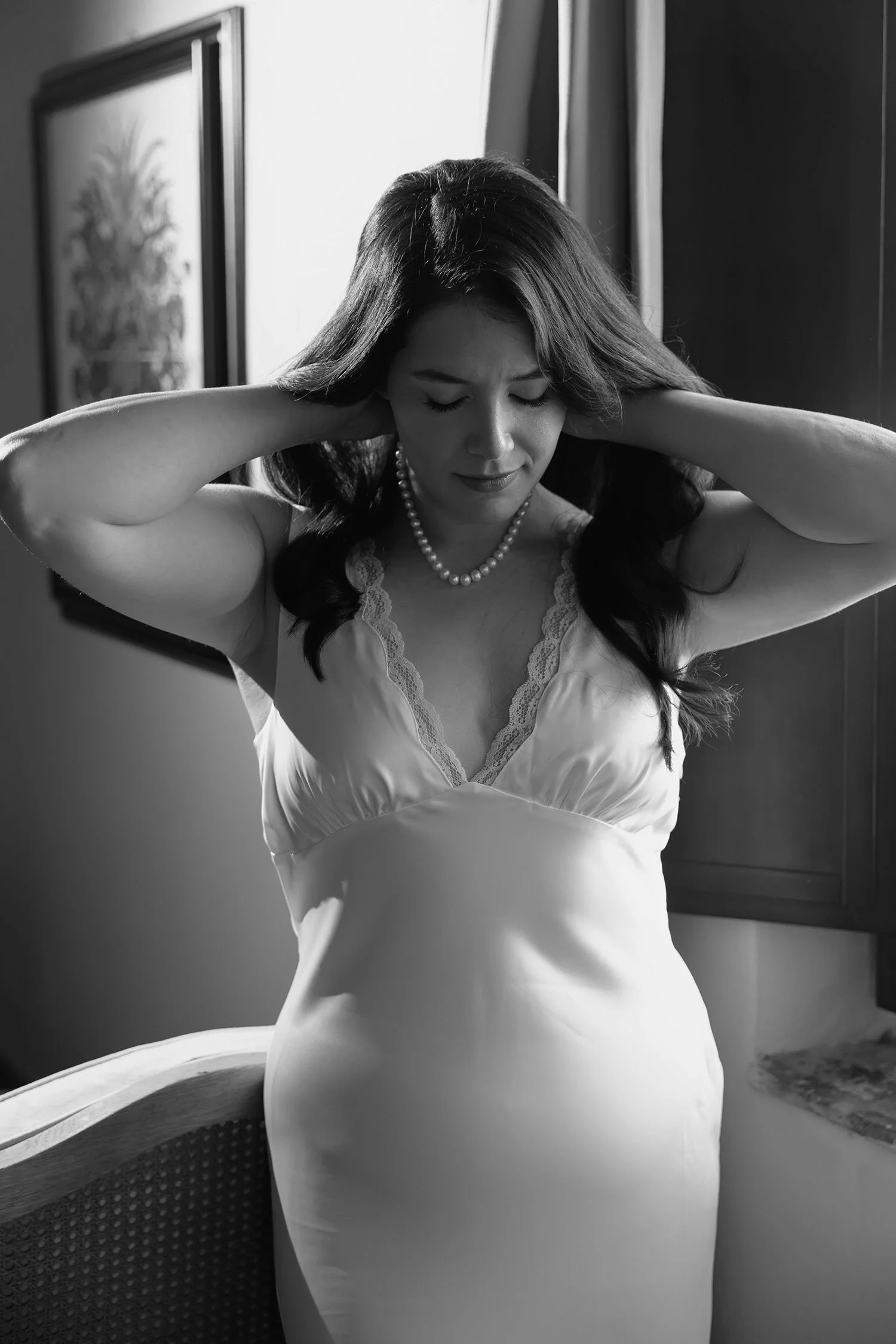 bride wearing necklace by the window