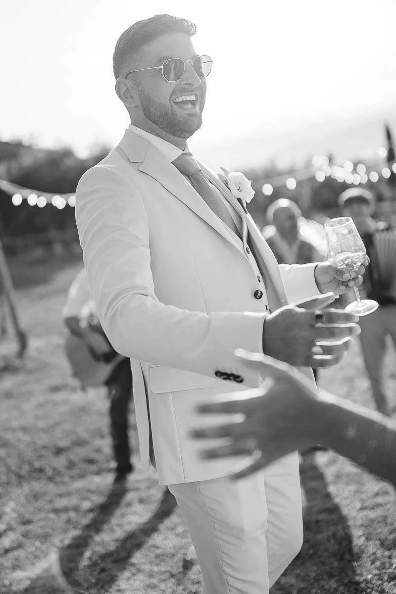 Destination wedding at Ristonchi castle near Florence in Tuscany. groom having fun during the cocktail