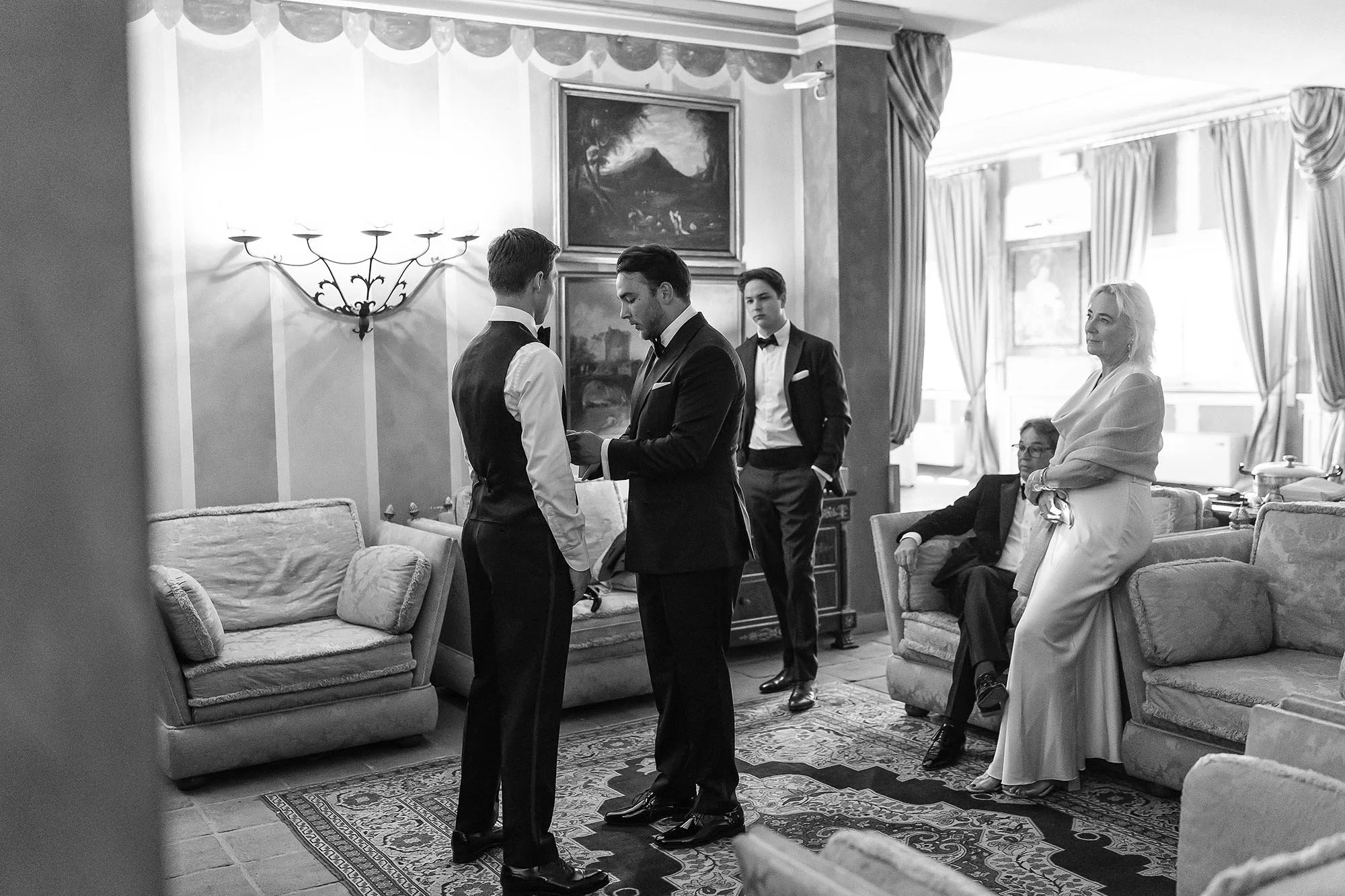 the groom is getting ready helped by his family